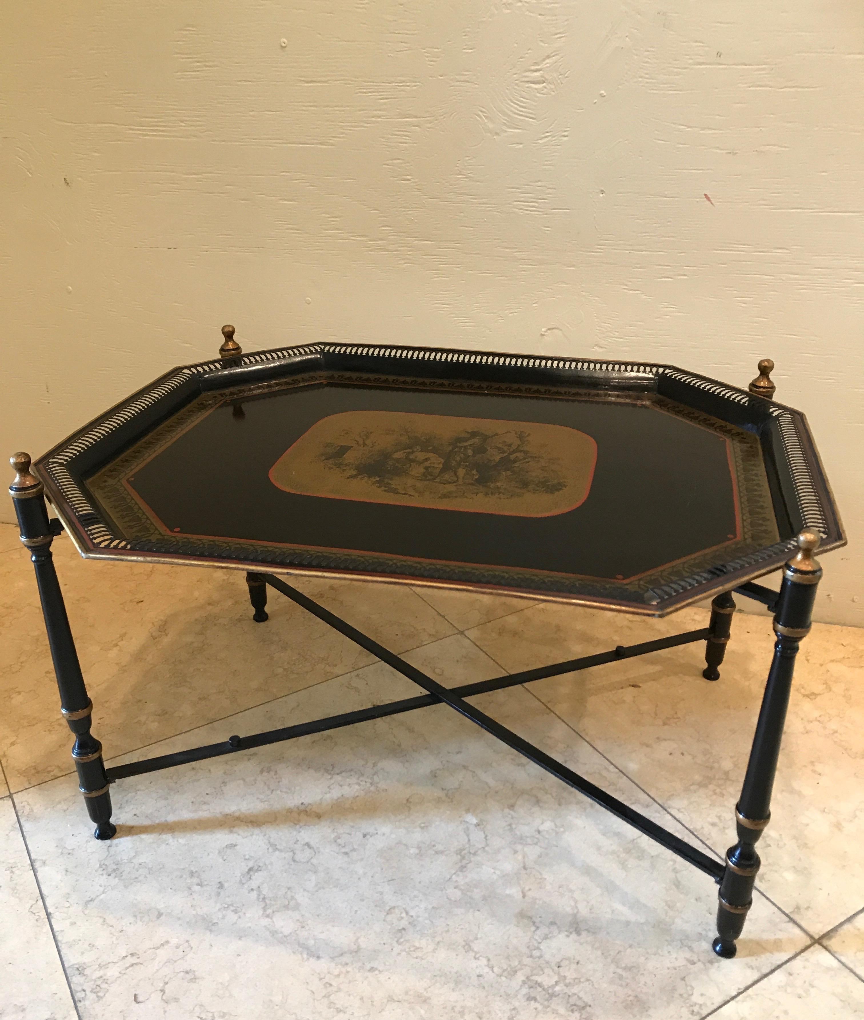 Black and gold tole tray table with a central scene.