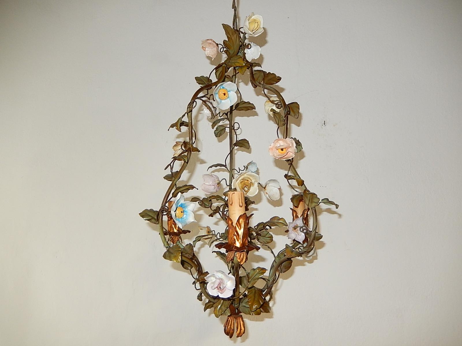 Housing five lights. Will be rewired and sockets for appropriate country. Original color tole with gold bulb holders. Handmade porcelain flowers, one petal broke and only flea bites. Adding 14 inches of original rare chain and gold canopy. Free