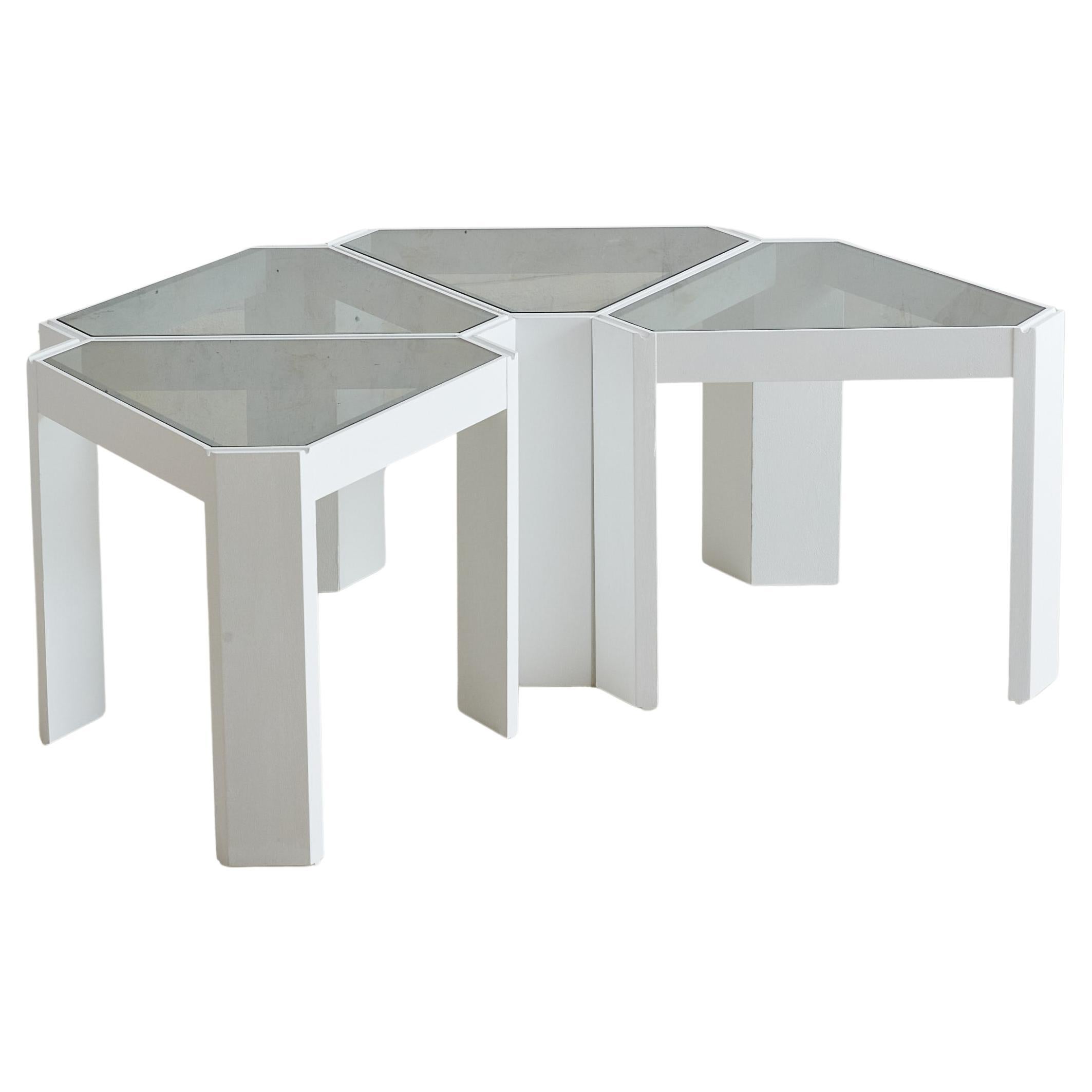 The ‘Tony’ triangular side table was designed by Porada Arredi in the 1970s. This table features a smoked glass top and white-finished wooden base, creating a clean, minimalist composition where smoky translucence contrasts with crisp, modern lines.