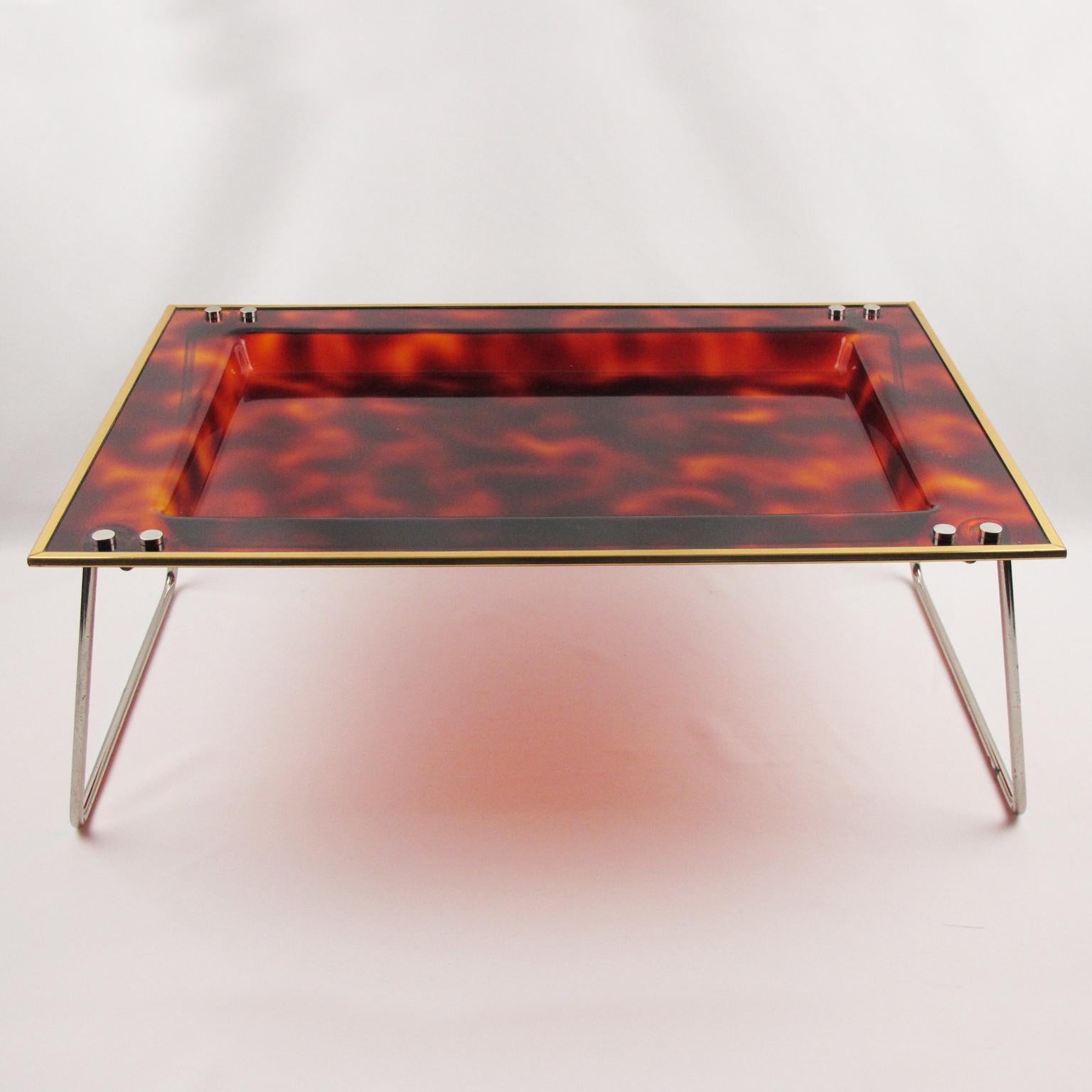 Pretty Italian Lucite and brass serving tray. Oversized rectangular shape barware butler folding tray with a translucent tortoiseshell textured pattern. The chromed metal legs fold up and are hinged, thus it can sit flat or raised. Perfect for