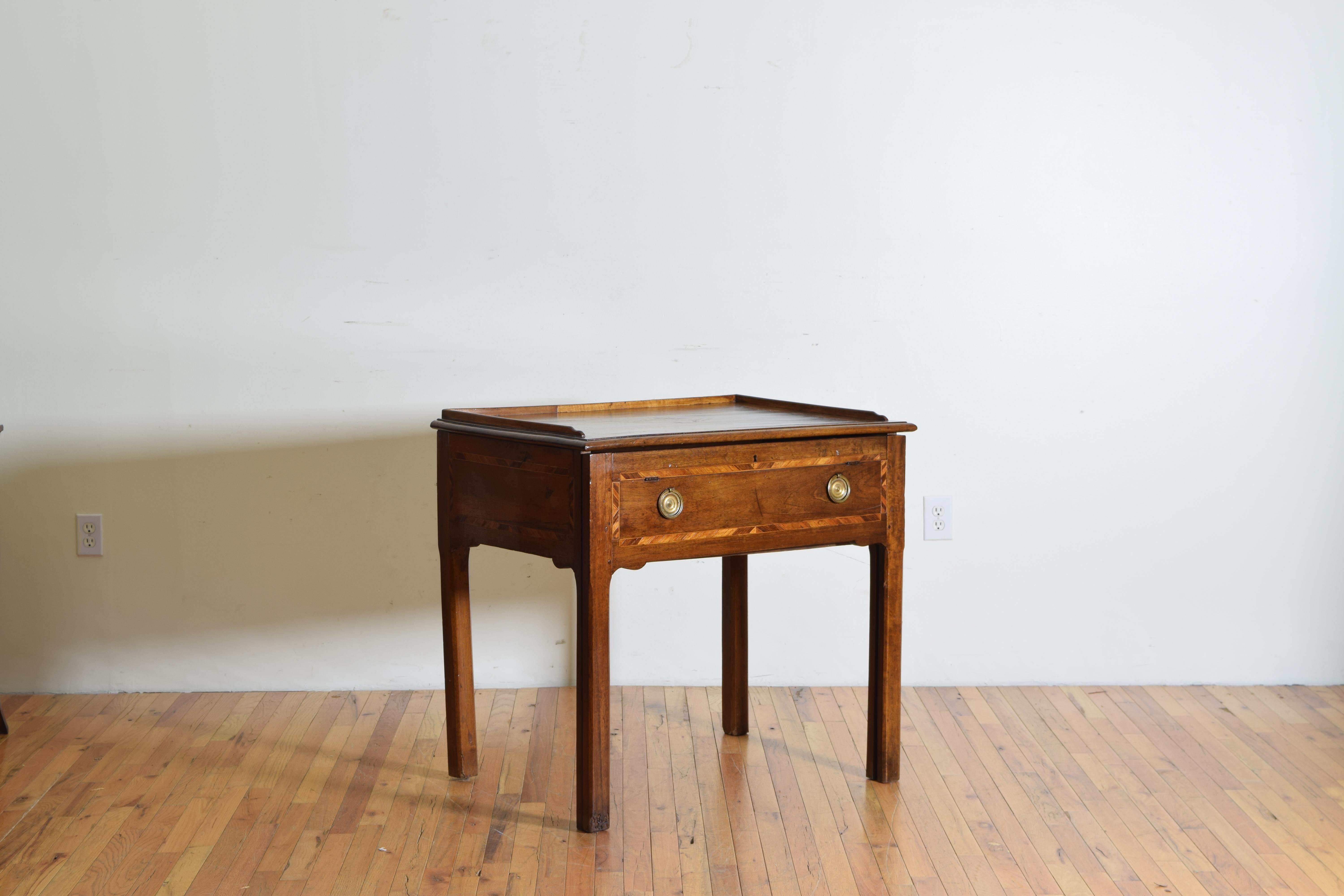 This desk has a line inlaid and central medallion inlaid rectangular top with a gallery edge, the case below sliding forward on joining front legs and the inner section having a sliding top and inner drawers and compartments, the front having false
