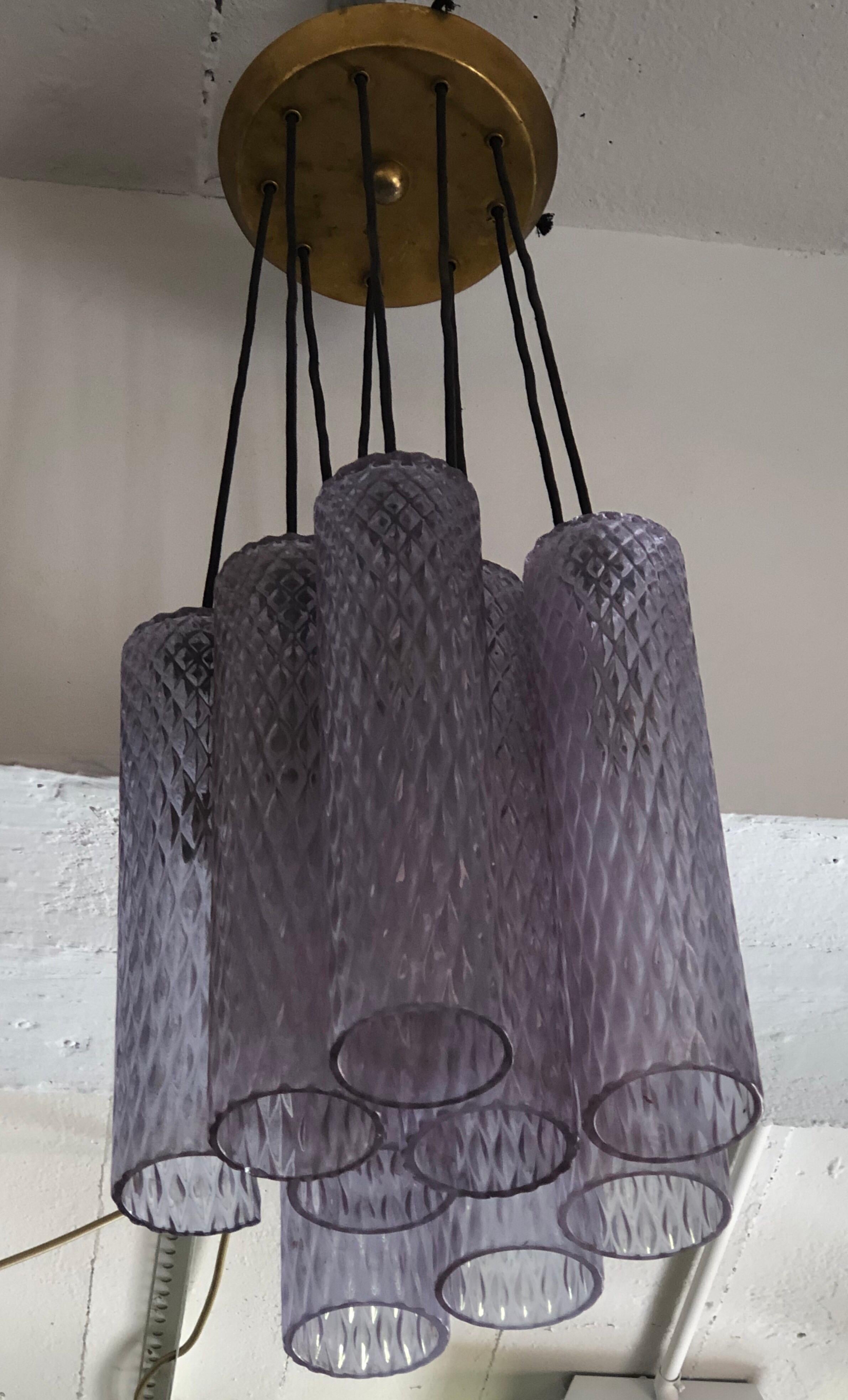 Italian Mid-Century Modern translucent purple Murano glass column pendant or chandelier attributed to Seguso with eight columns, each lighted with one chandelier socket. The glass of each column is 12
