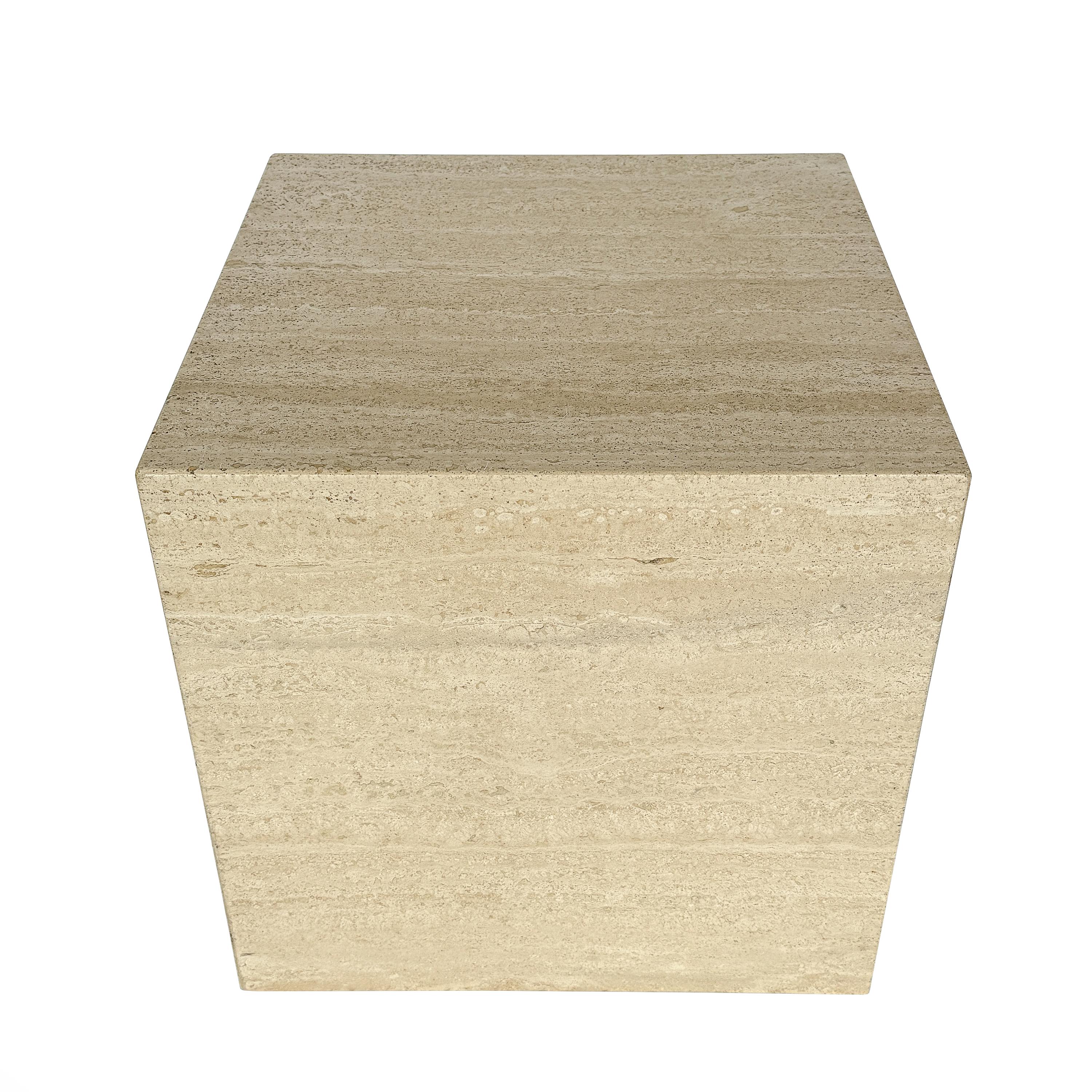 Immerse yourself in the pure essence of minimalist design with this Italian travertine cube side table, Italy circa 1970s. Each face of the cube exudes a serene elegance, with the natural beauty of filled travertine stone offering a tactile and