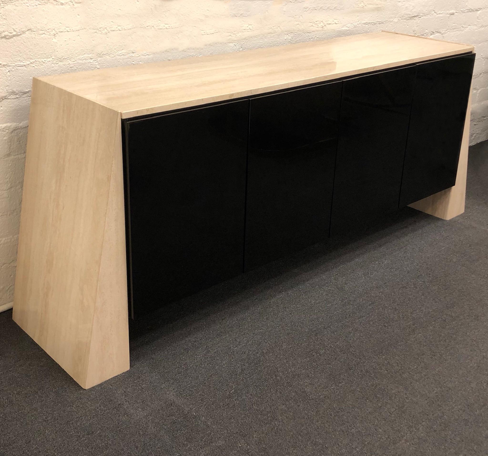 A spectacular polish Italian travertine and polish black lacquer credenza from the 1980s. The inside is all black on one side there’s a drawer with a dinner wear organizer and an adjustable shelf. Newly professionally polished.
Dimensions: 84” wide