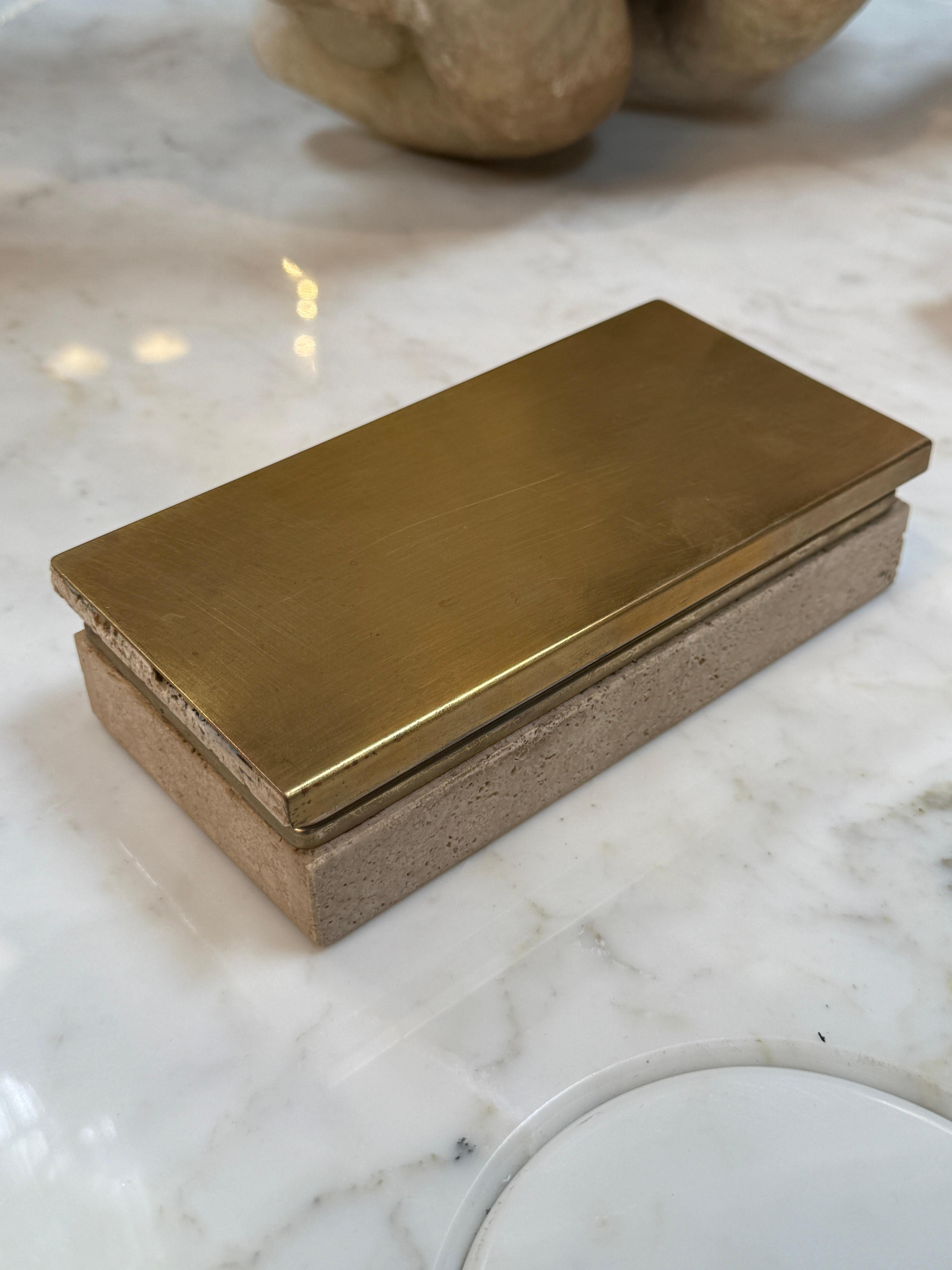 A mid-century modern Italian-style travertine and brass box, blending natural stone with sleek metallic accents. It’s both decorative and functional, used for storing small items while also serving as a stylish display piece.

