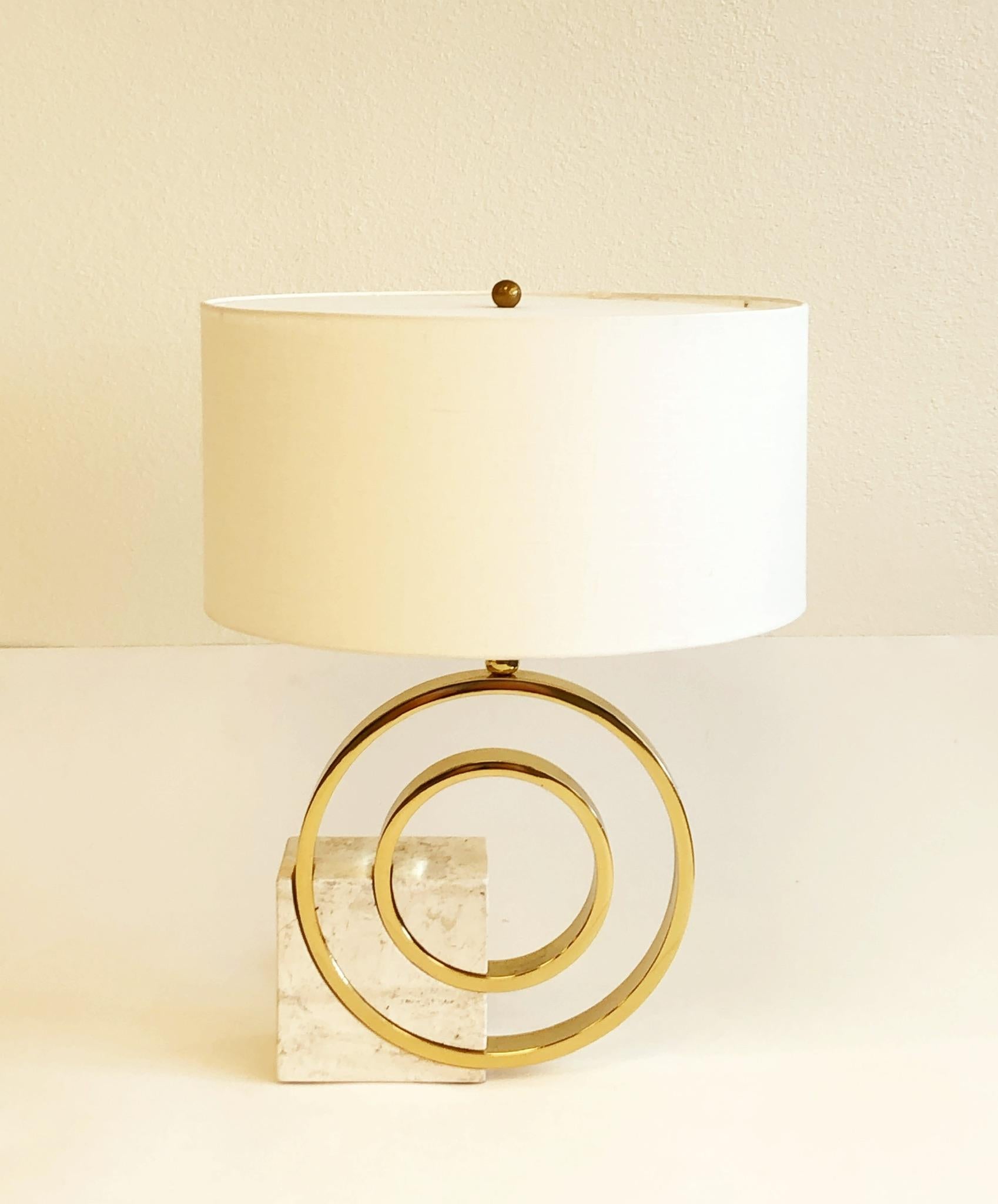 A sculptural Italian travertine and polish brass table lamp designed in the 1970’s by Giovanni Banci for Banci Firenze. The lamp has been newly rewired with new polish brass hardware and new vanilla linen shade. The shade diffuser is made out of