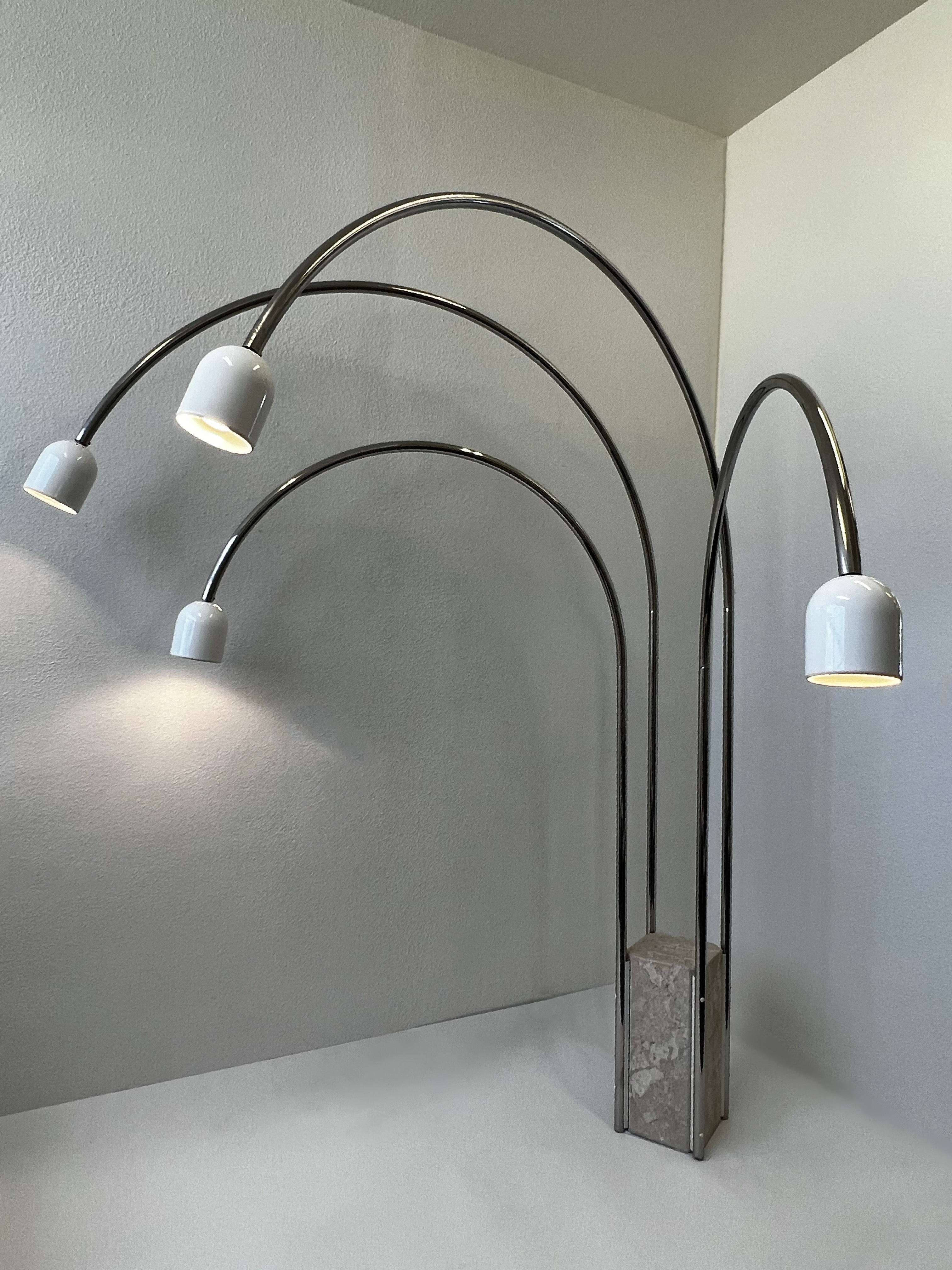 Rare Italian adjustable arch floor lamp by Goffredo Reggiani.
Constructed of travertine, chrome tubing and white powder coated shades. 
In beautiful vintage condition. 
Newly rewired. 
All arms rotate and it takes four 75w. Max Edison light bulbs.
