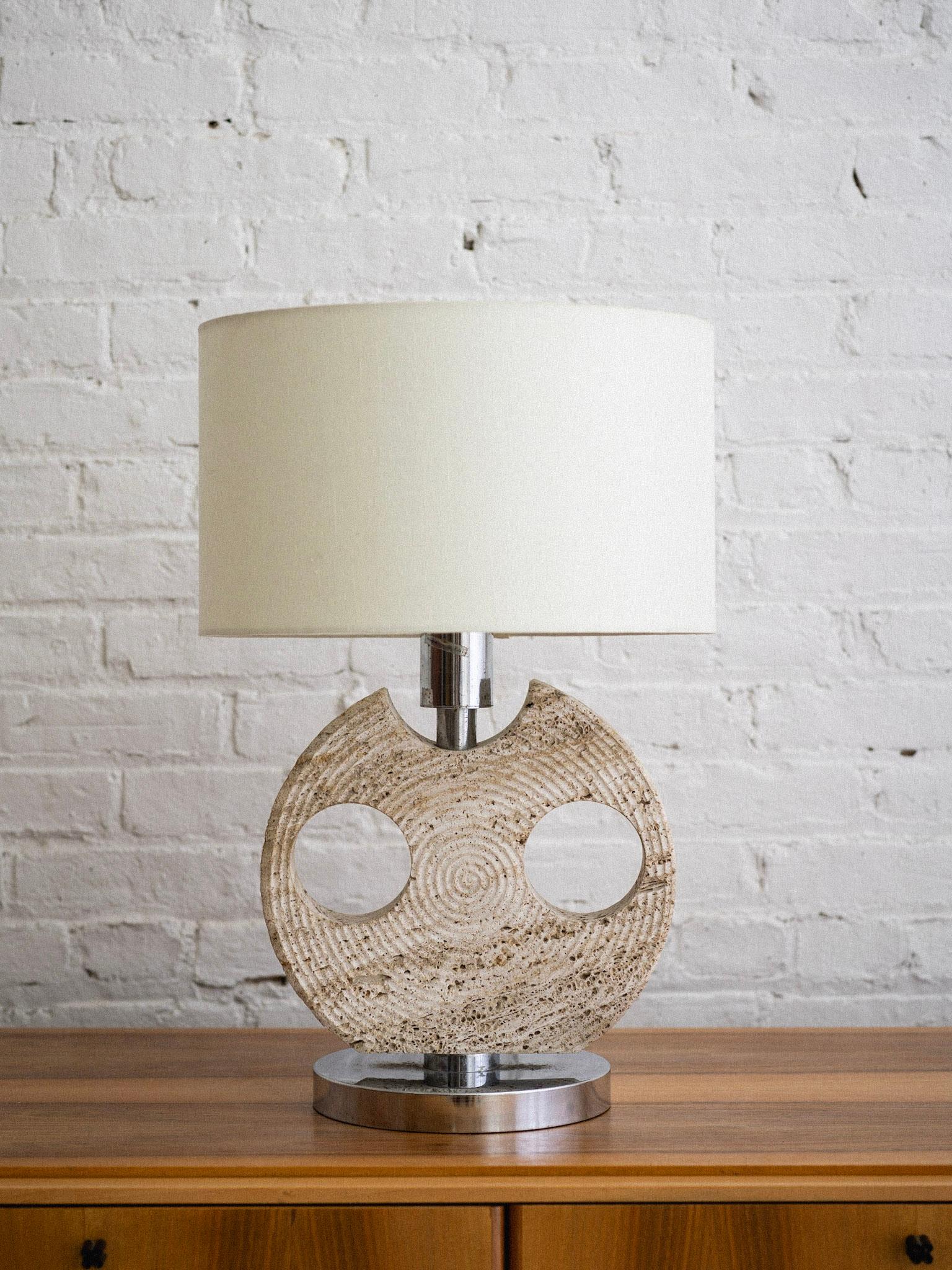 A travertine and chrome table lamp by CE. VA Designer Study. Chrome base and hardware support a piece of solid travertine cut with a textured graphic pattern. Lamp shade not included. Sourced in Northern Italy.