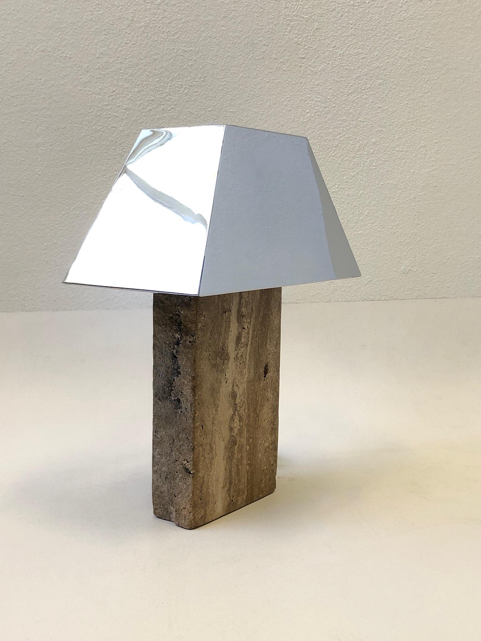 1980’s Italian travertine with a polished chrome shade table lamp in the manner of Karl Springer. 
The travertine is polished on the front and back, the sides are left natural rough texture. 
Purchased with several other KS items from a Steve