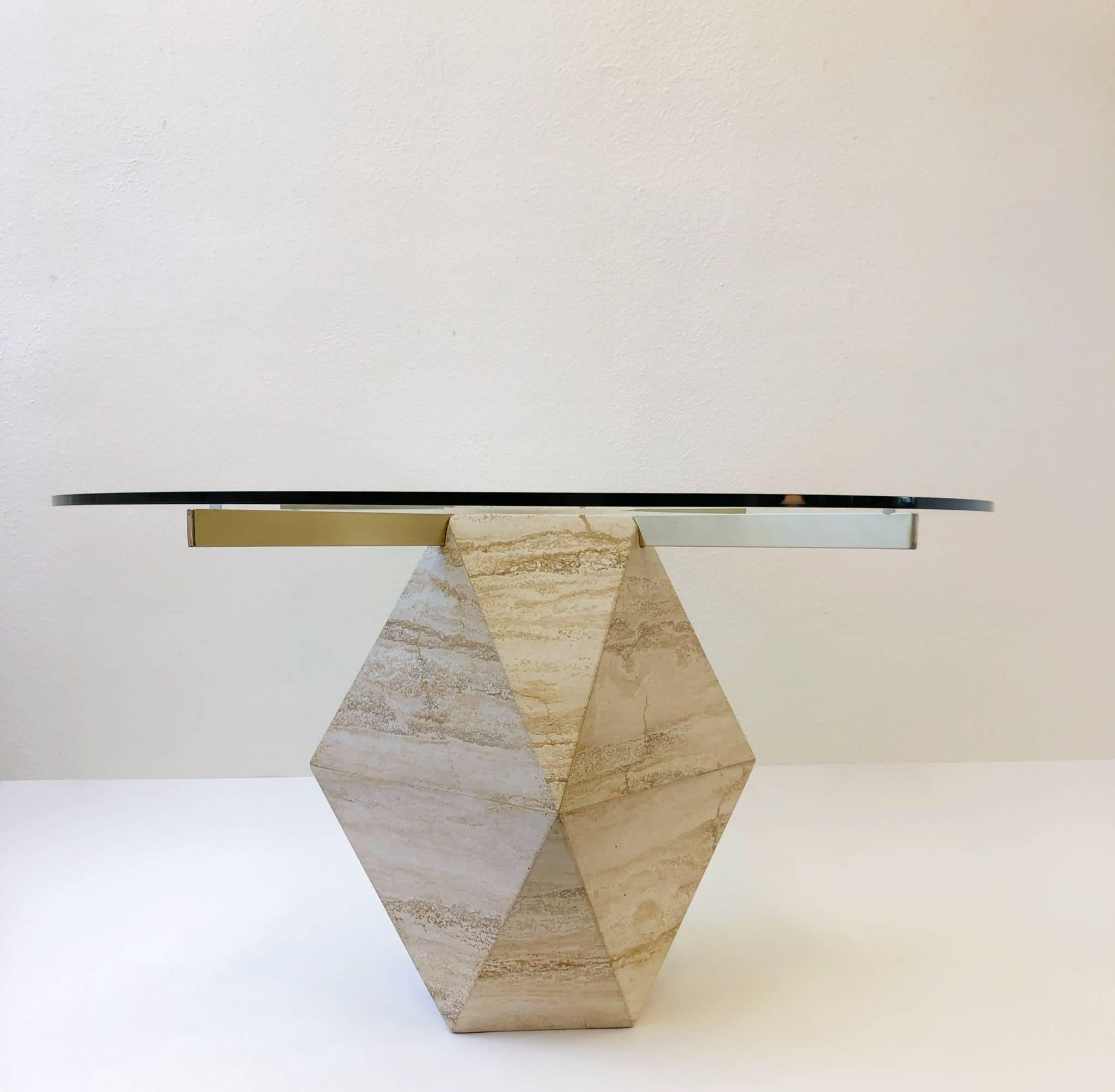 A sculptural Italian travertine dining table design by Artedi in the 1970s.
The table is constructed of Italian travertine and satin brass with a 48” in diameter 1/2” thick glass top. 

Dimensions: 48” diameter 28.5” high.