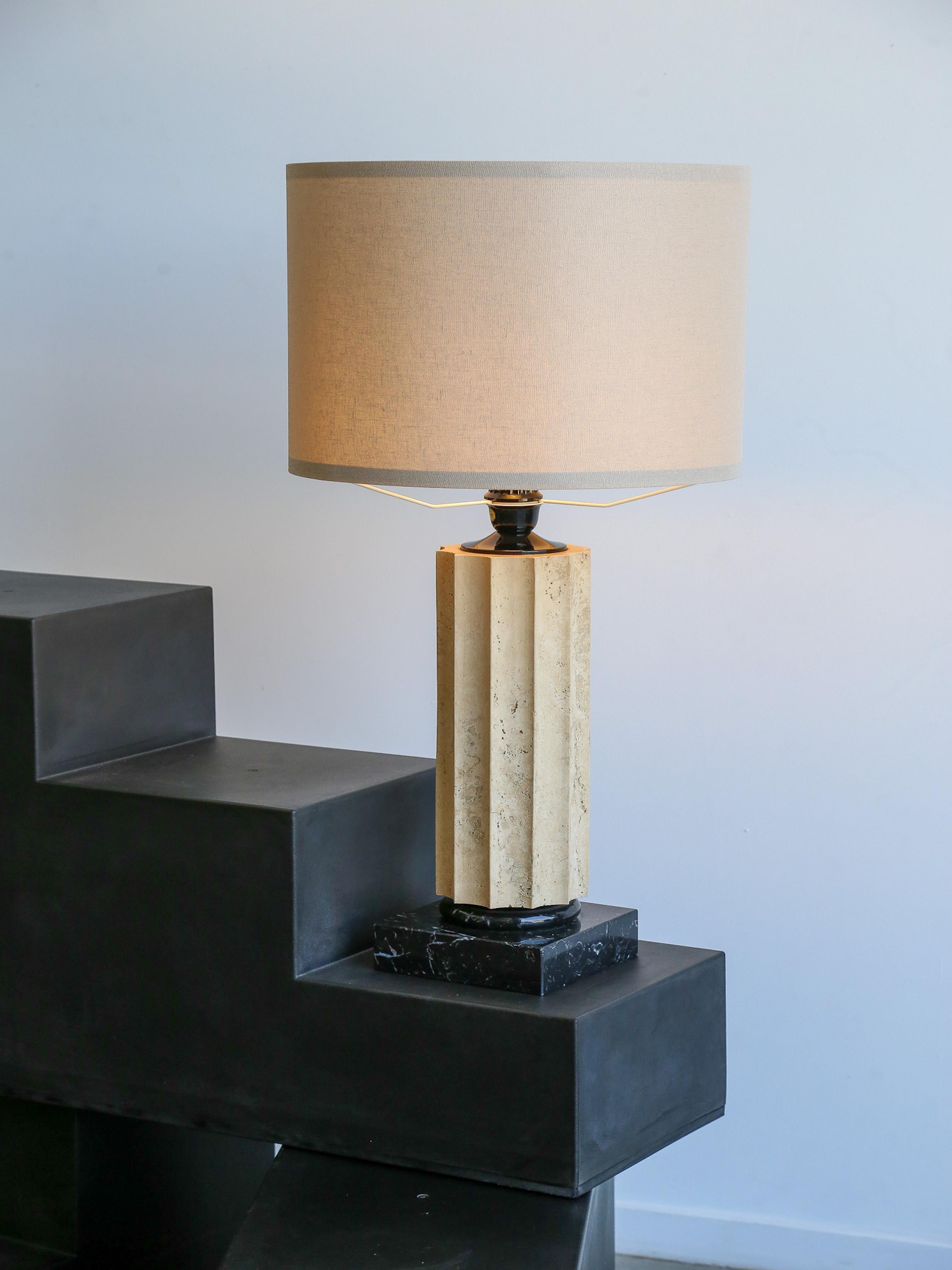 Travertine is a type of limestone rock, known for its natural, porous texture and creamy coloration, often featuring distinctive veining or patterns. Black marble, on the other hand, is a type of marble characterized by its black color with varying