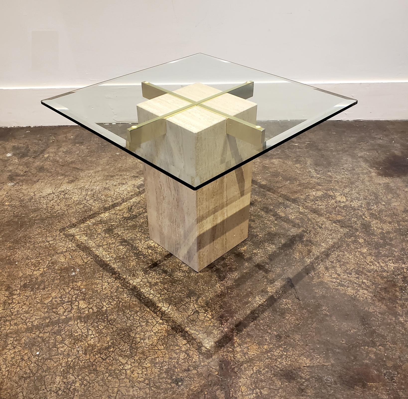 Modern side or occasional table with rectangular travertine stone base, brass cross bars and beveled glass top. Made in Italy in the 1980s. Decorative and endlessly adaptable little table. Can be used as a nightstand, side table, lamp table,