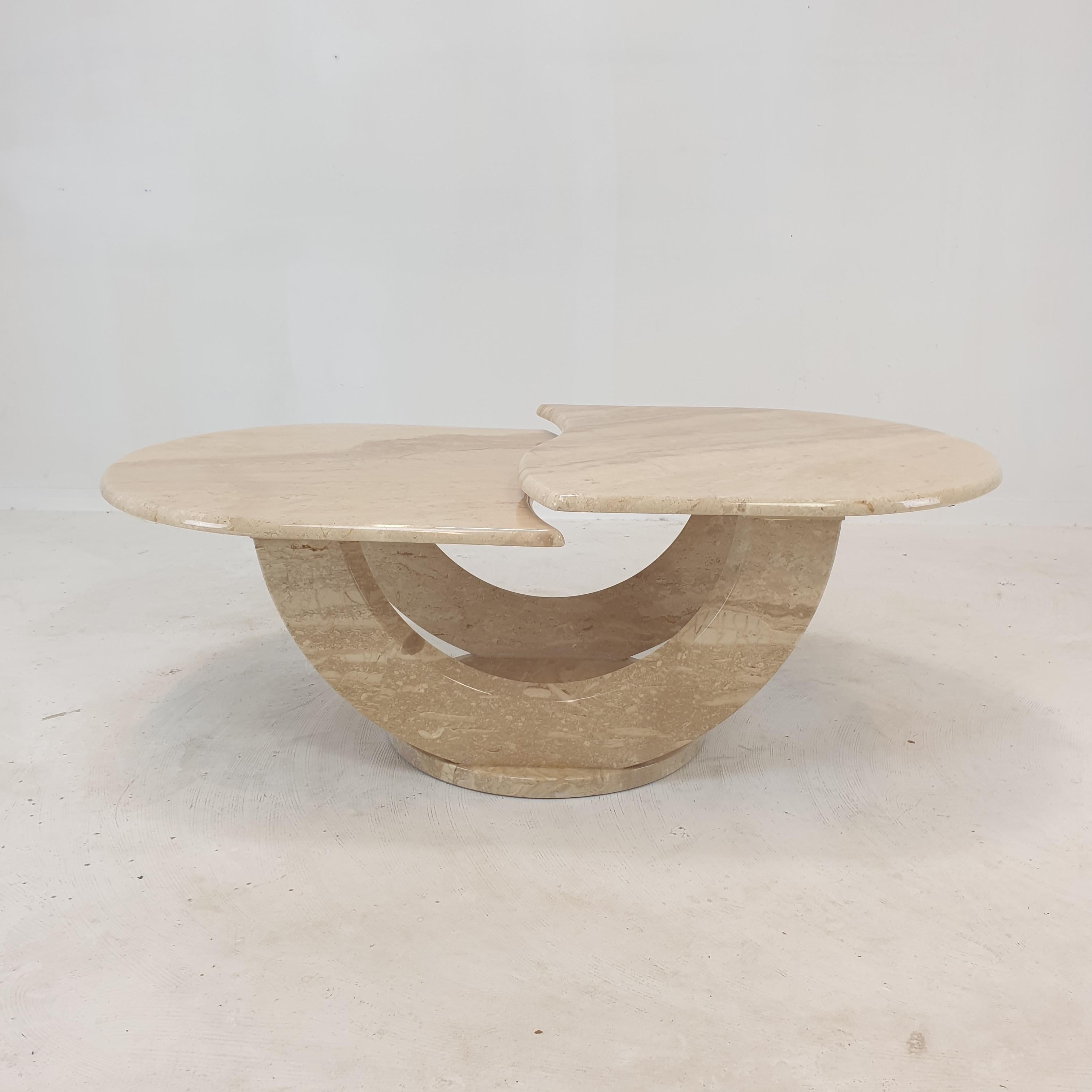 Very nice and rare Italian coffee table, fabricated in the 80's. 

Two beautiful shaped plates on a very elegant base. 
The plates are rounded on the edge. 

This lovely table is made of beautiful travertine.

We work with professional