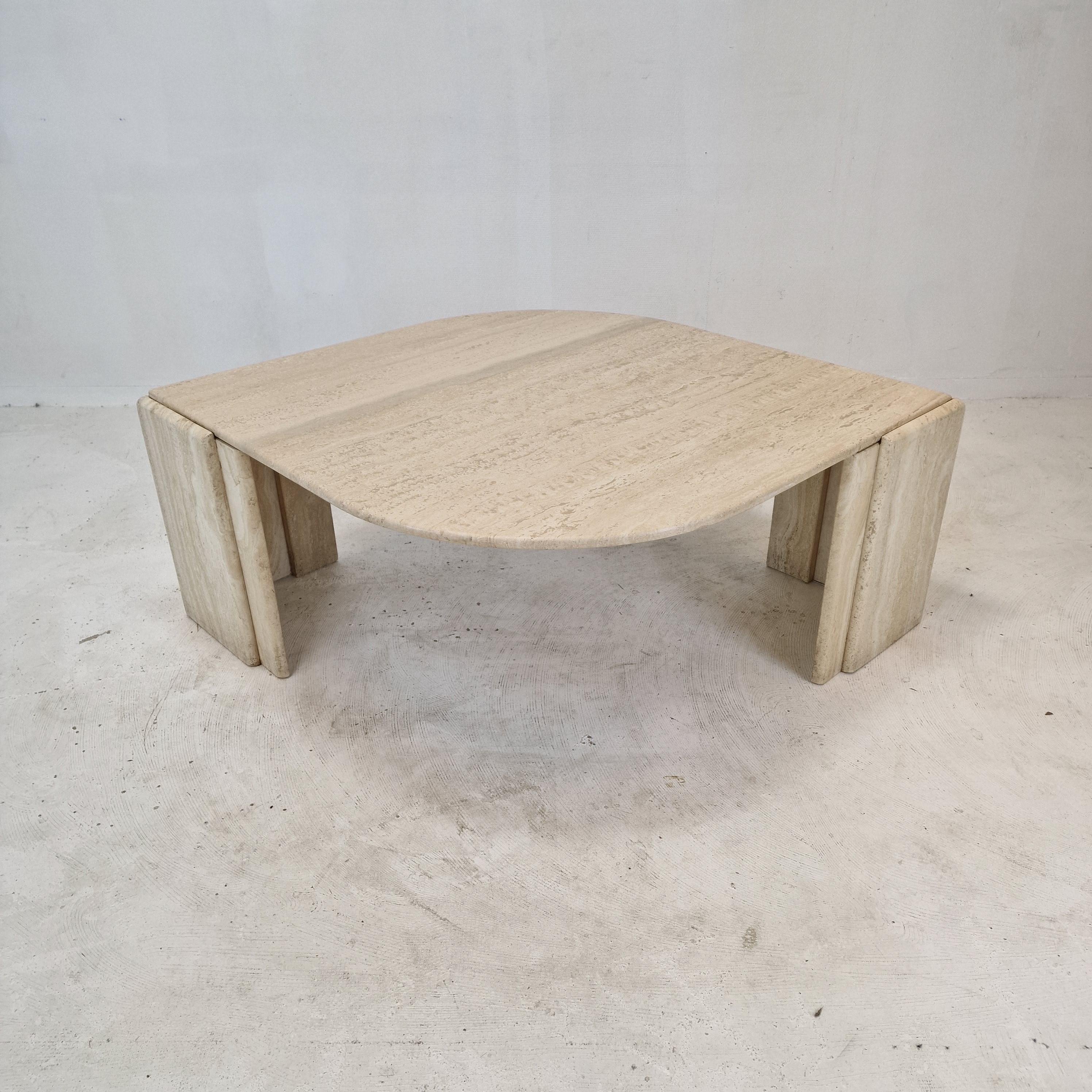 Very elegant Italian coffee table handcrafted out of travertine, 1980's.

The beautiful teardrop shaped top is rounded on the edge. 
It is made of beautiful travertine.

The base is made of two separate pieces.

It has the normal traces of