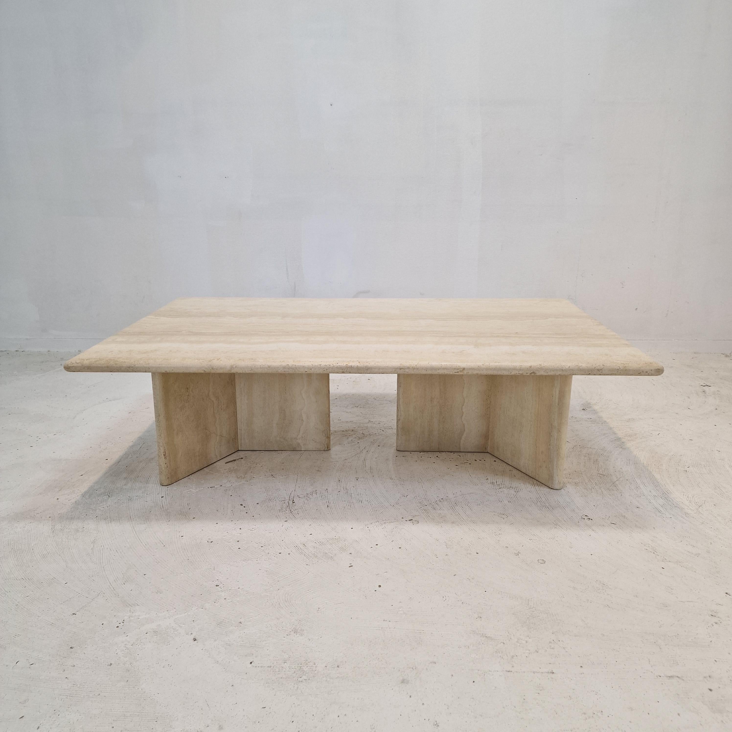 Superbe table basse italienne fabriquée à la main en travertin, années 1980.

Le magnifique plateau rectangulaire est arrondi sur le bord. 
Il est fait d'un magnifique travertin.
Veuillez prendre note des très beaux motifs.

Il possède deux très