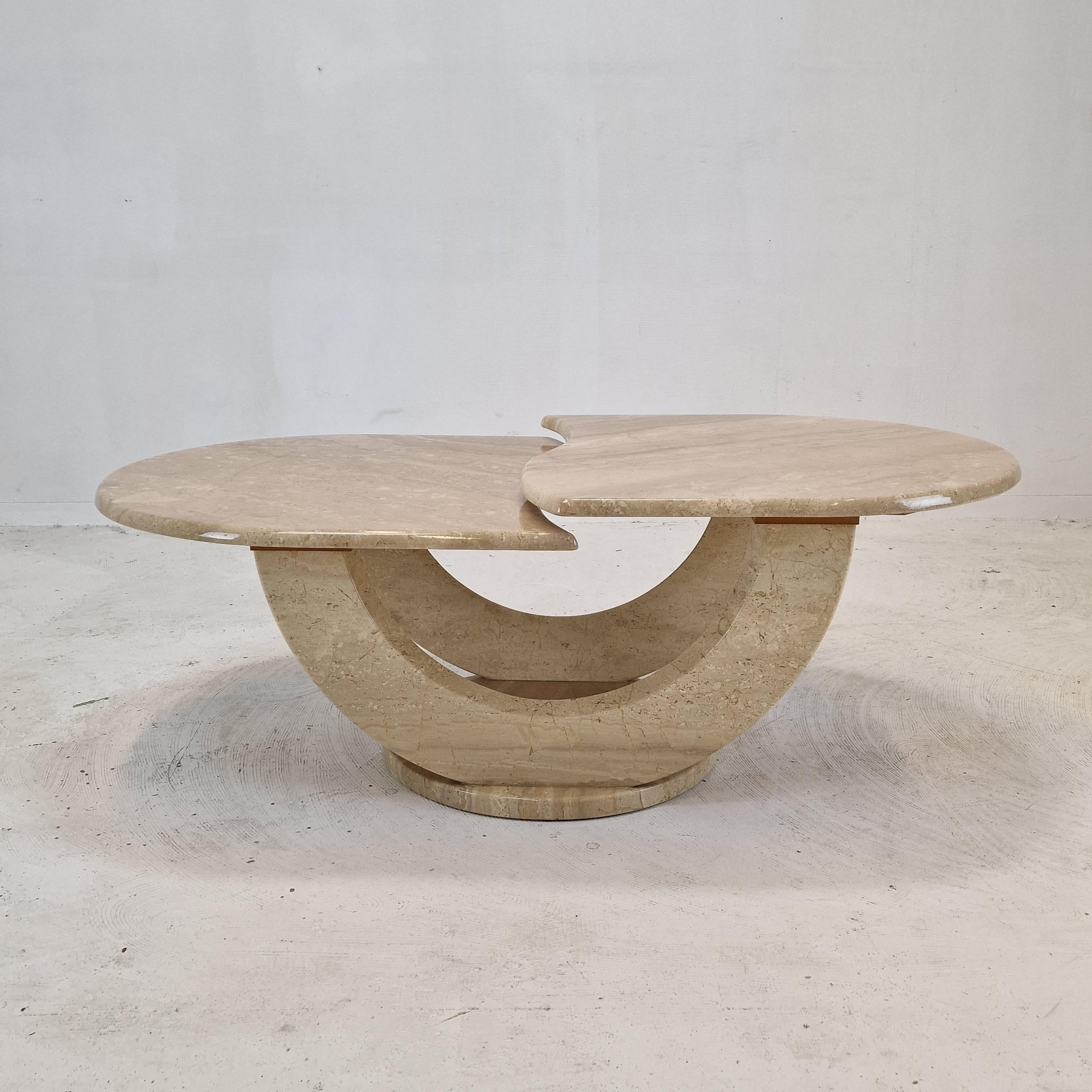 Very nice Italian coffee or side table handcrafted out of travertine, 1980s. 

Two beautiful shaped plates on a very elegant base.  
The plates are rounded on the edge.  

It is made of beautiful travertine. 
Please take notice of the very nice