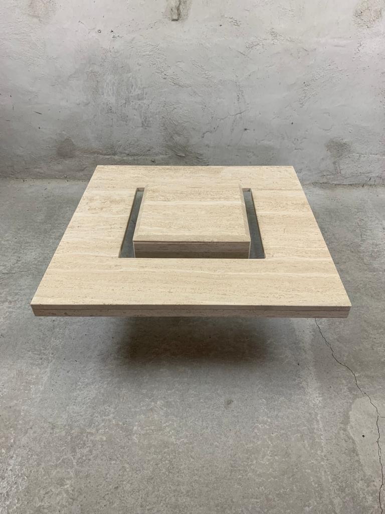 Wonderful travertine coffee table with a floating top plate. 

The square base supports a glass plate which holds te travertine top, giving the impression that the top floats in the air, giving the piece a very elegant look. 

Dimensions: W. 86cm,