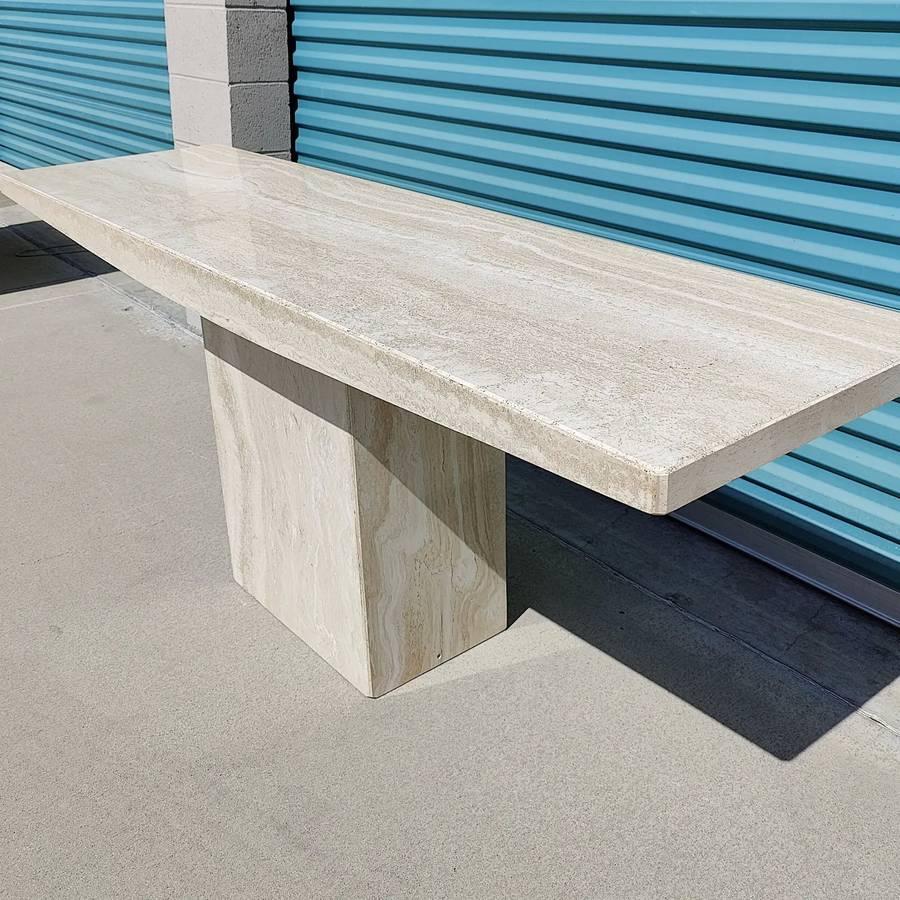 Solid travertine console table by Stone International. Measures approximately 71.25w x 20d x 29.25t. Overall in great condition. Would benefit from a buff!.