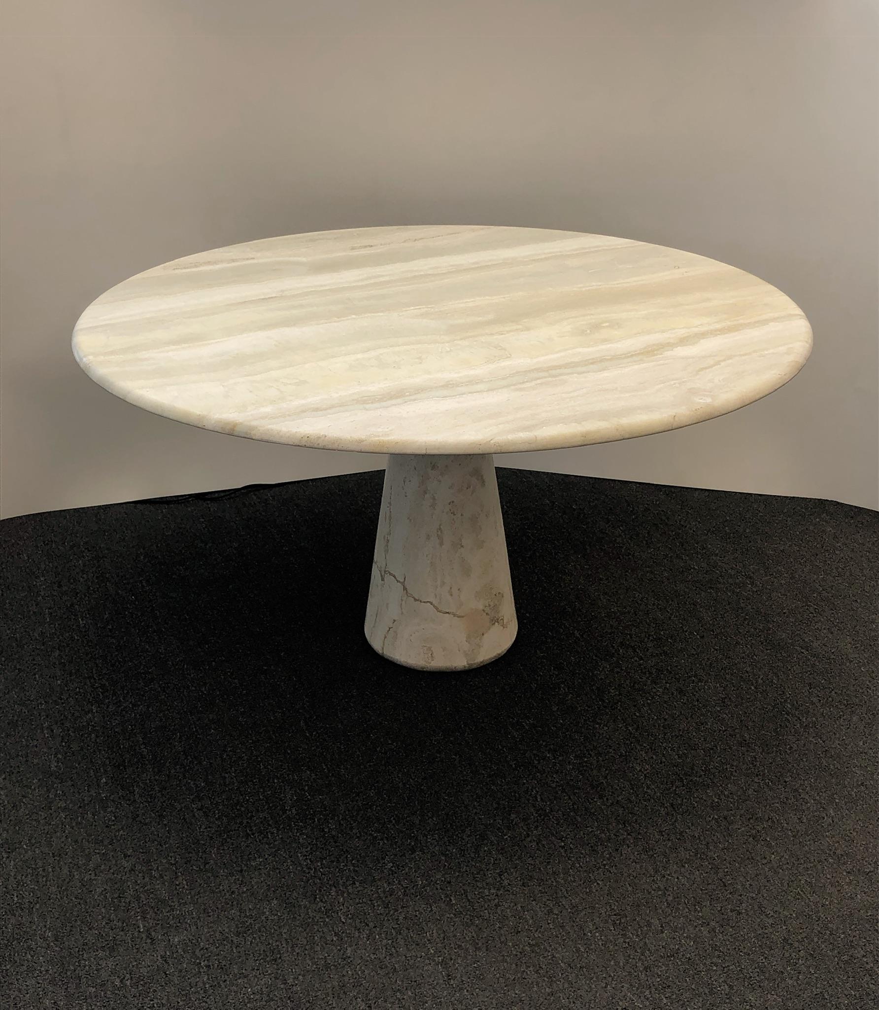 A spectacular 1970s solid Italian travertine continental height table in the manner of Angelo Mangiarroti. The table is in two sections and has been newly professionally polished in a satin finish. 

Dimensions: 27” high, 51” diameter.