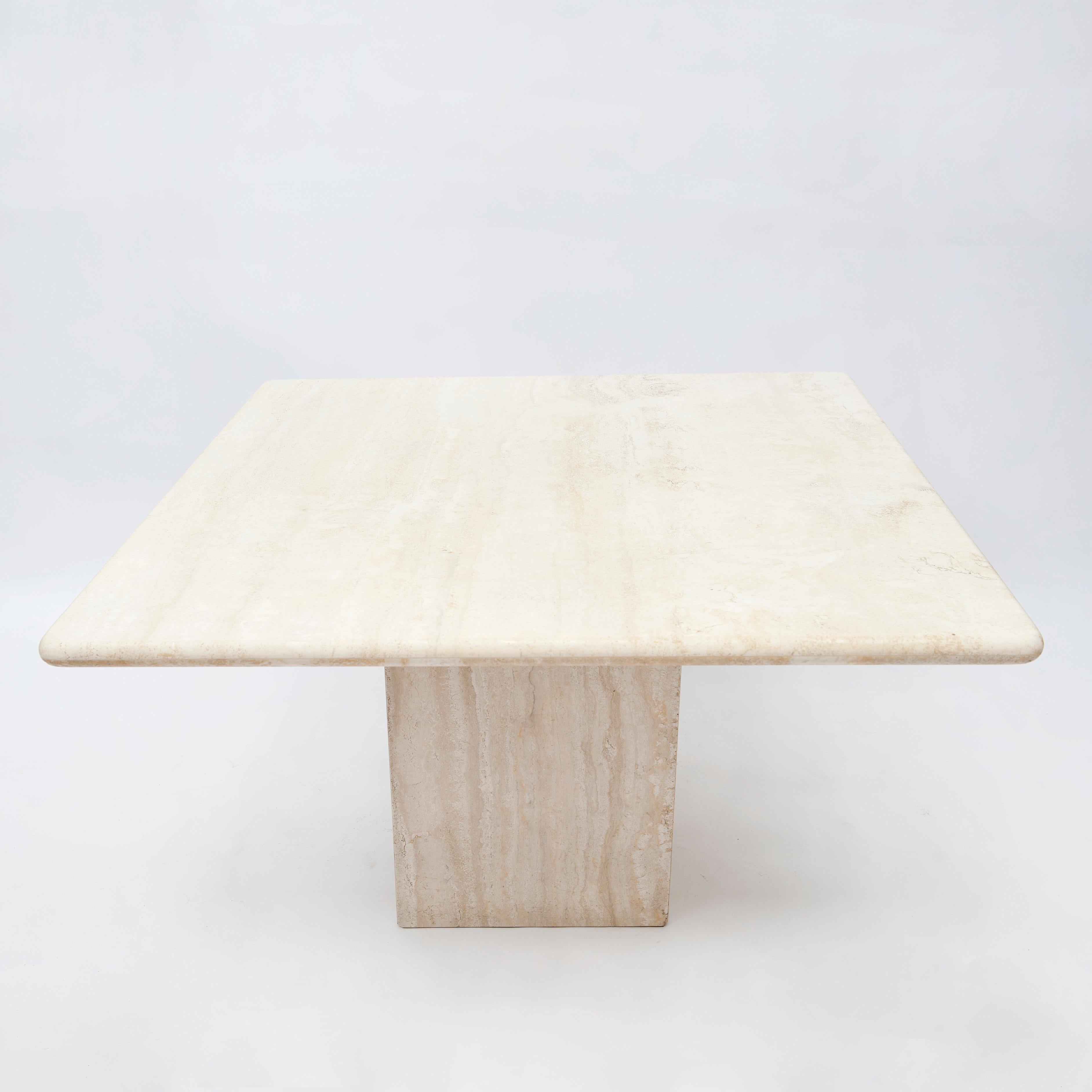 Italian travertine dining table produced end 1970s-begin 1980s. The condition is very good without any damages or repairs. The square top measures 120 x 120 cm. H 72 cm. The minimalistic simplicity of design would compliment many design projects.