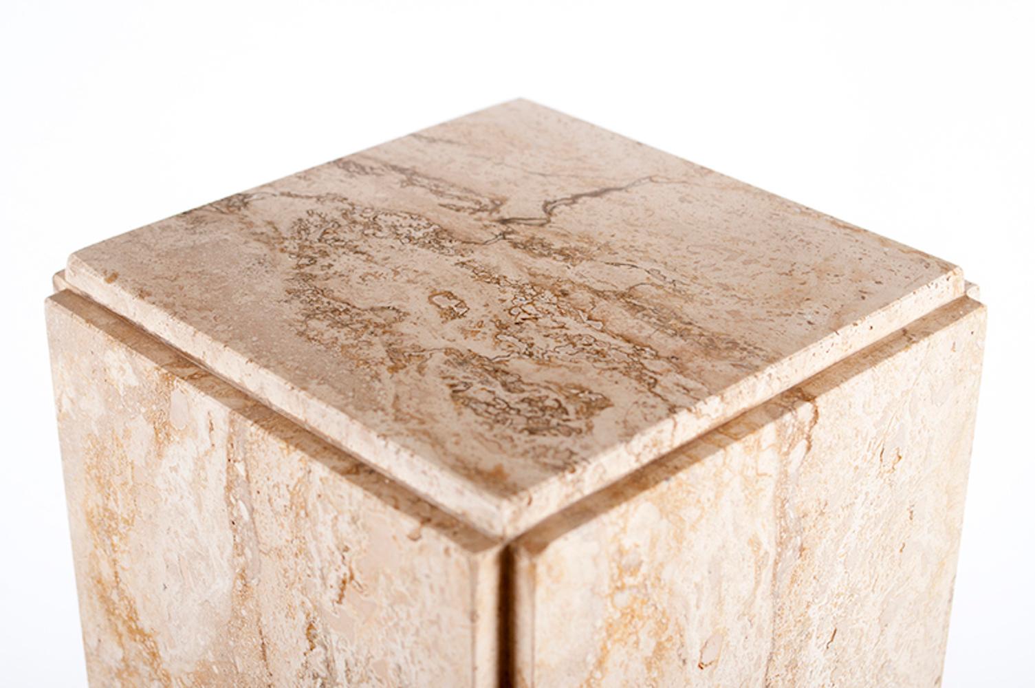 A vintage neutral toned rectangular travertine pedestal made in Italy. Standing 27’ tall, the pedestal is comprised of five slabs of marble situated on each other so that the corners are not flush. There are four felt pads on the bottom of the