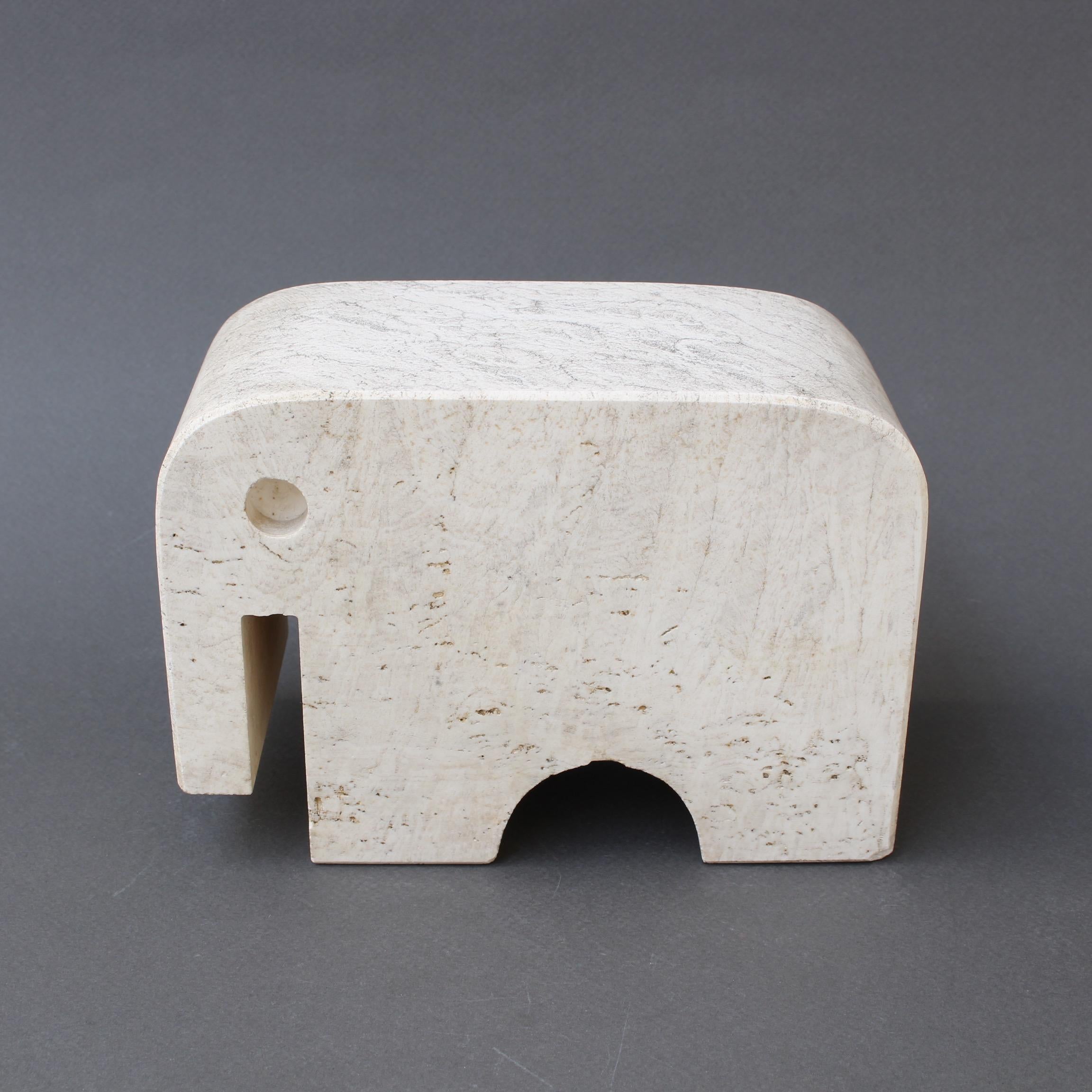 Travertine elephant table sculpture by Mannelli Bros., Florence, Italy (circa 1970s). Joyful travertine stylized elephant will delight art lovers and collectors. Minimalist in style with soft curves and lines, this sculpture may be displayed as a