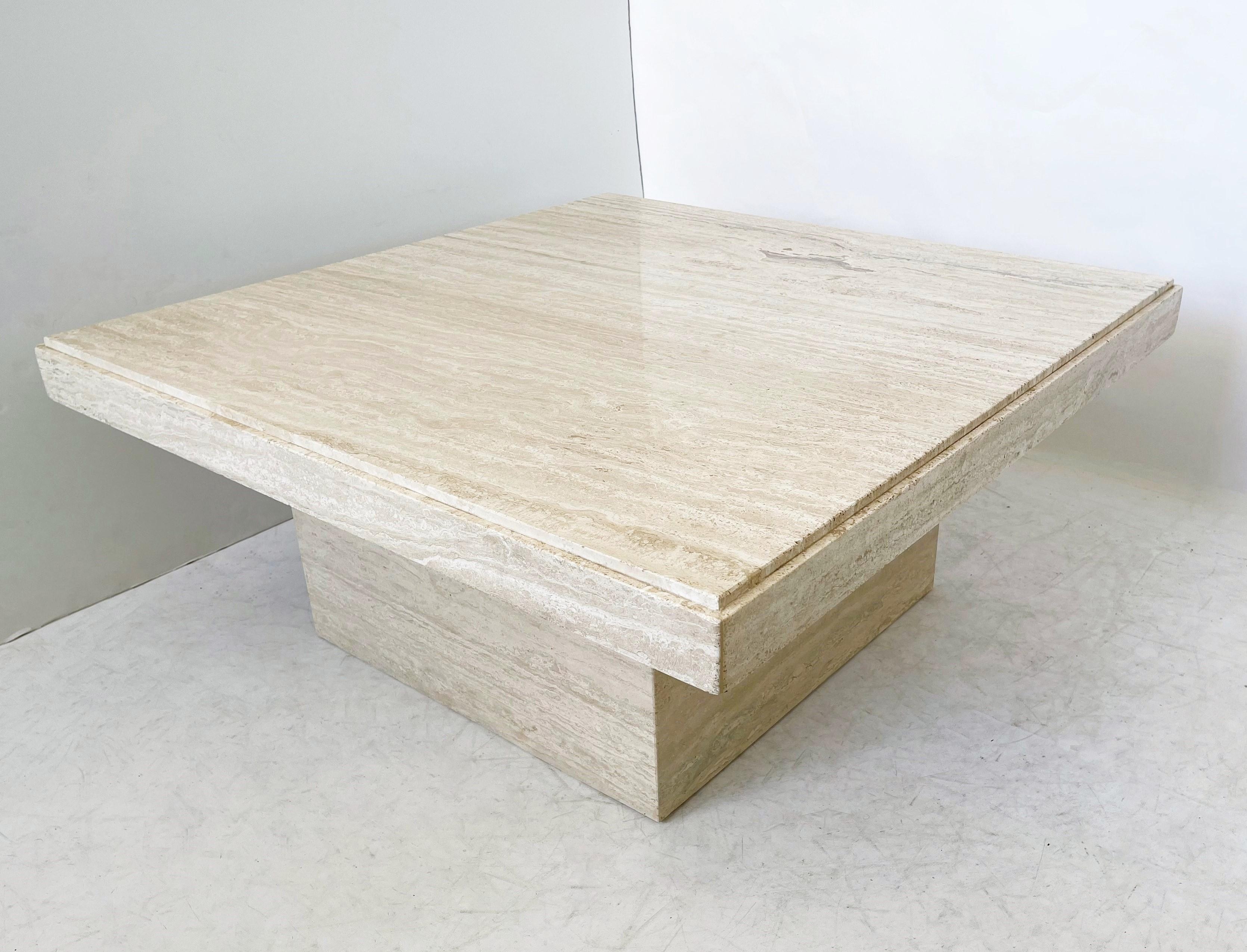 Pure Minimalist Italian modern travertine marble low/cocktail table in the manner of Angelo Mangiarotti, circa 1970. With gorgeous veining polished travertine square table top with beveled edge supported on a center square pedestal base. This piece