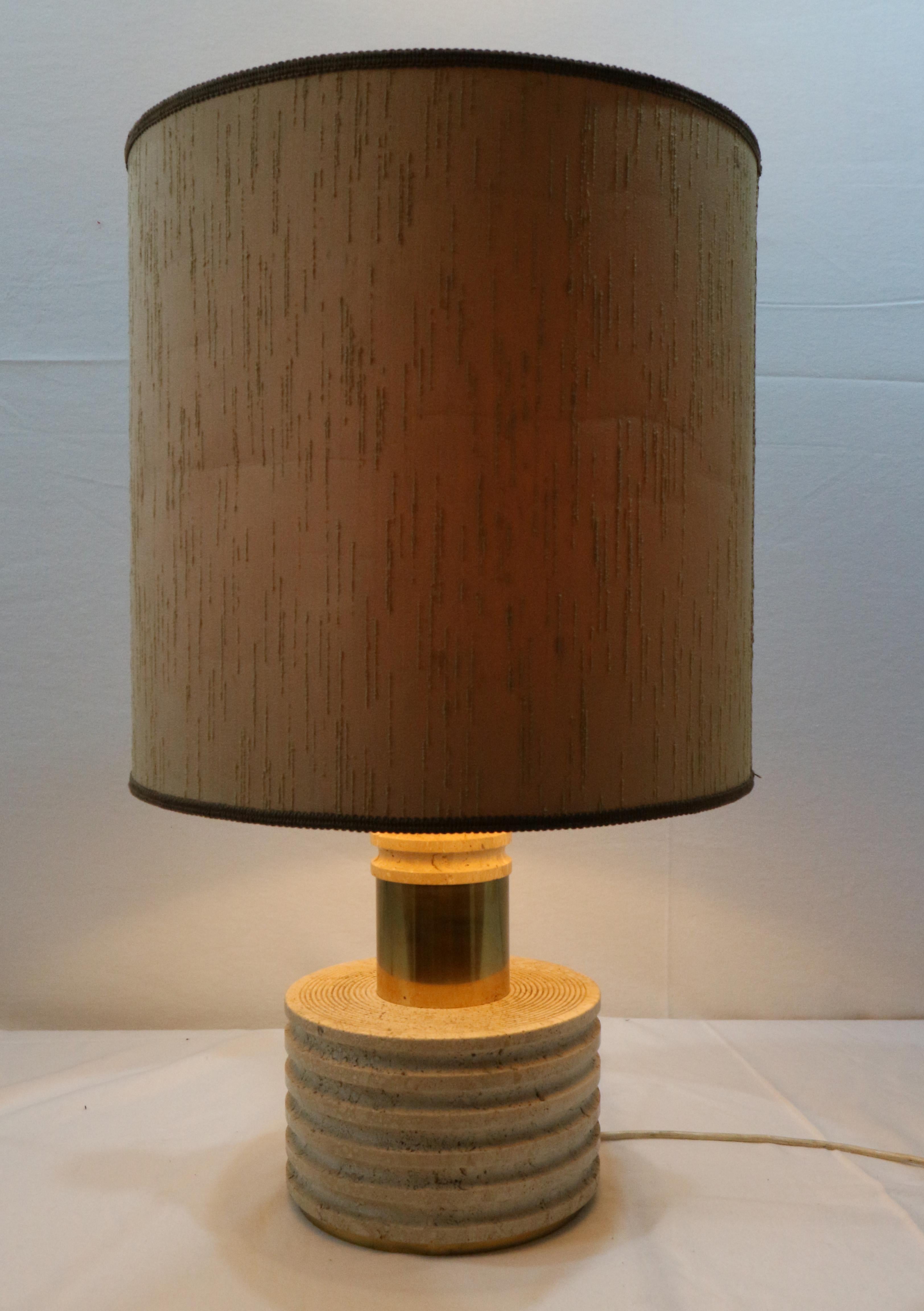 Table lamp in carved travertine.
Made with two blocks of circular shape, both carved, joined by brass elements.
It presents the manufacturer's label under the base (see photo in detail).
Produced in Italy around 1970.
Measure space of