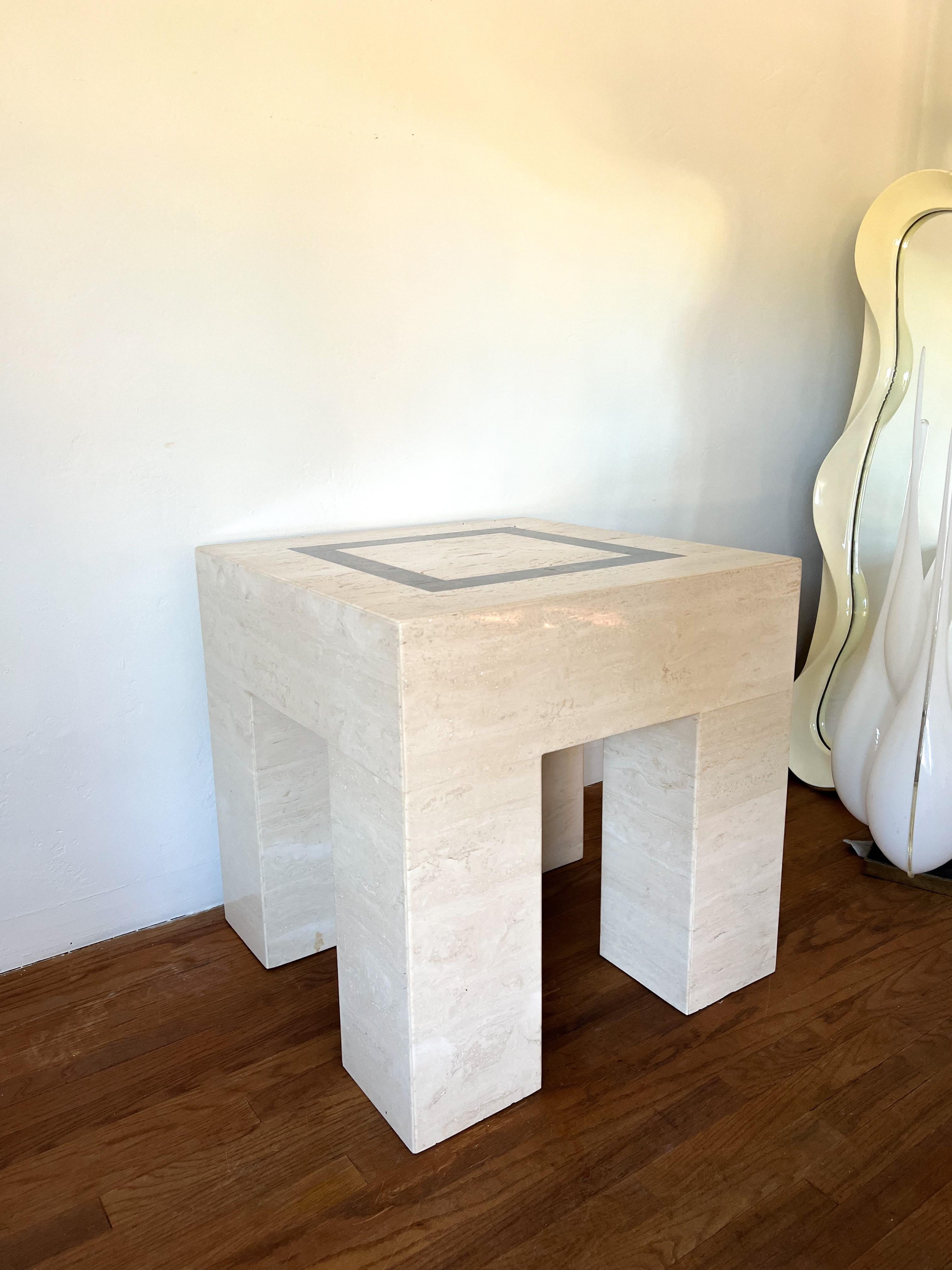 This is a beautifully-crafted sculptural side table made out of solid travertine. The legs are chunky 
