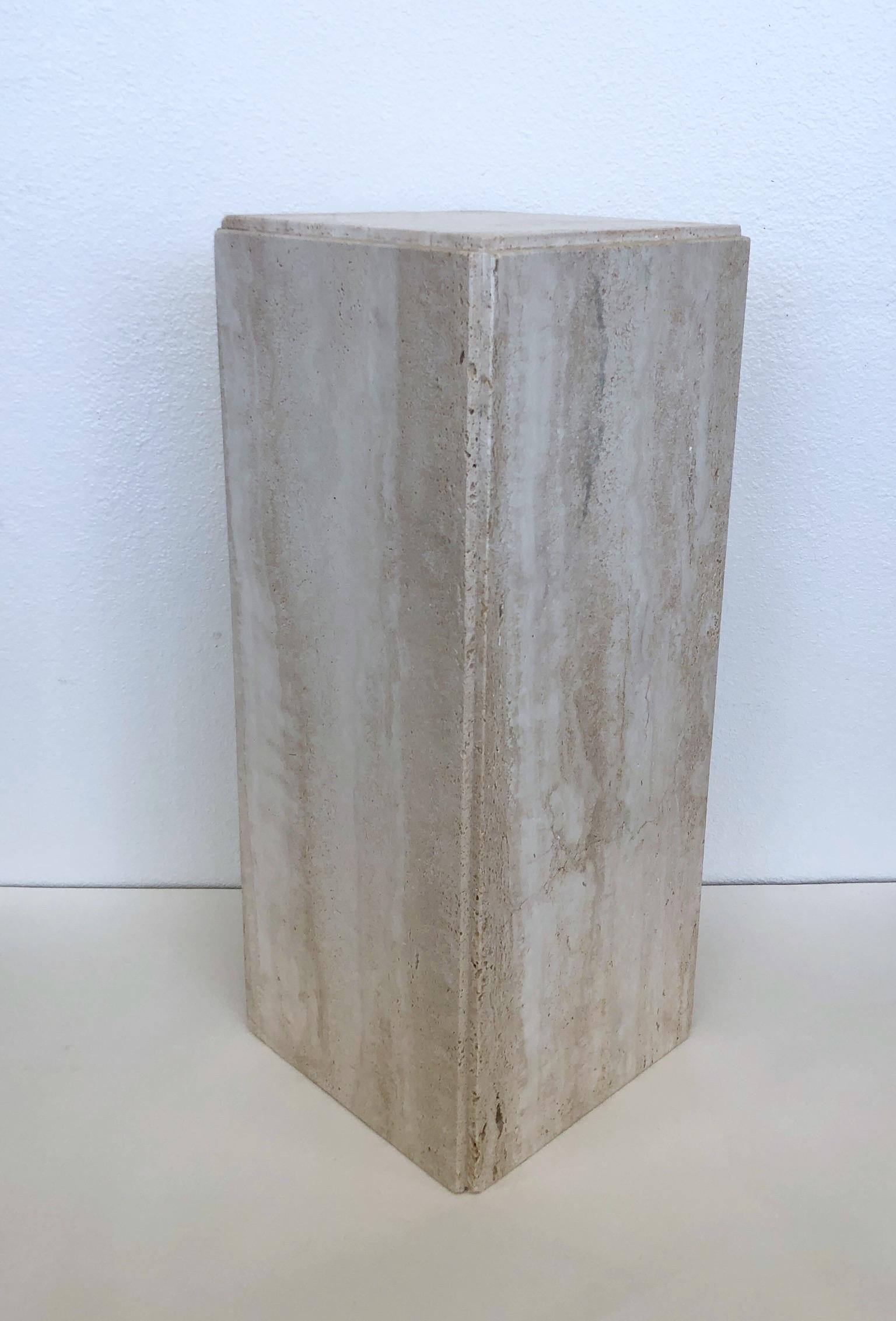 1970’s Italian travertine pedestal.
In original condition, this is not polished. 
Measurements: 10.5” Wide, 10.5” Deep, 25.5” High.