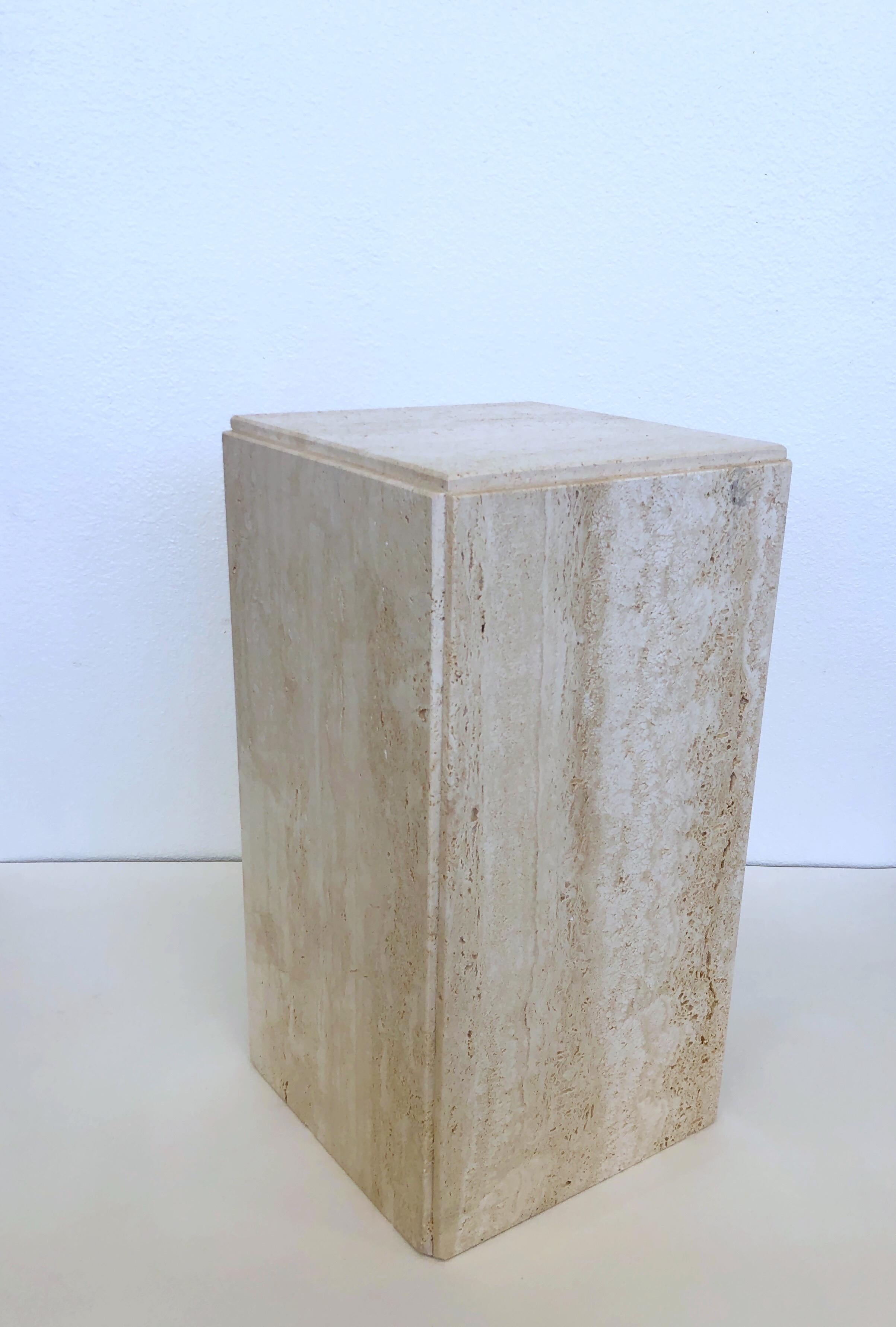 Small Italian travertine pedestal. 
In original condition, not polished. 
We do have a taller pedestal in a separate listing(see image 5). 
Measurements: 10.5” wide, 10.5” deep, 19.75” high.