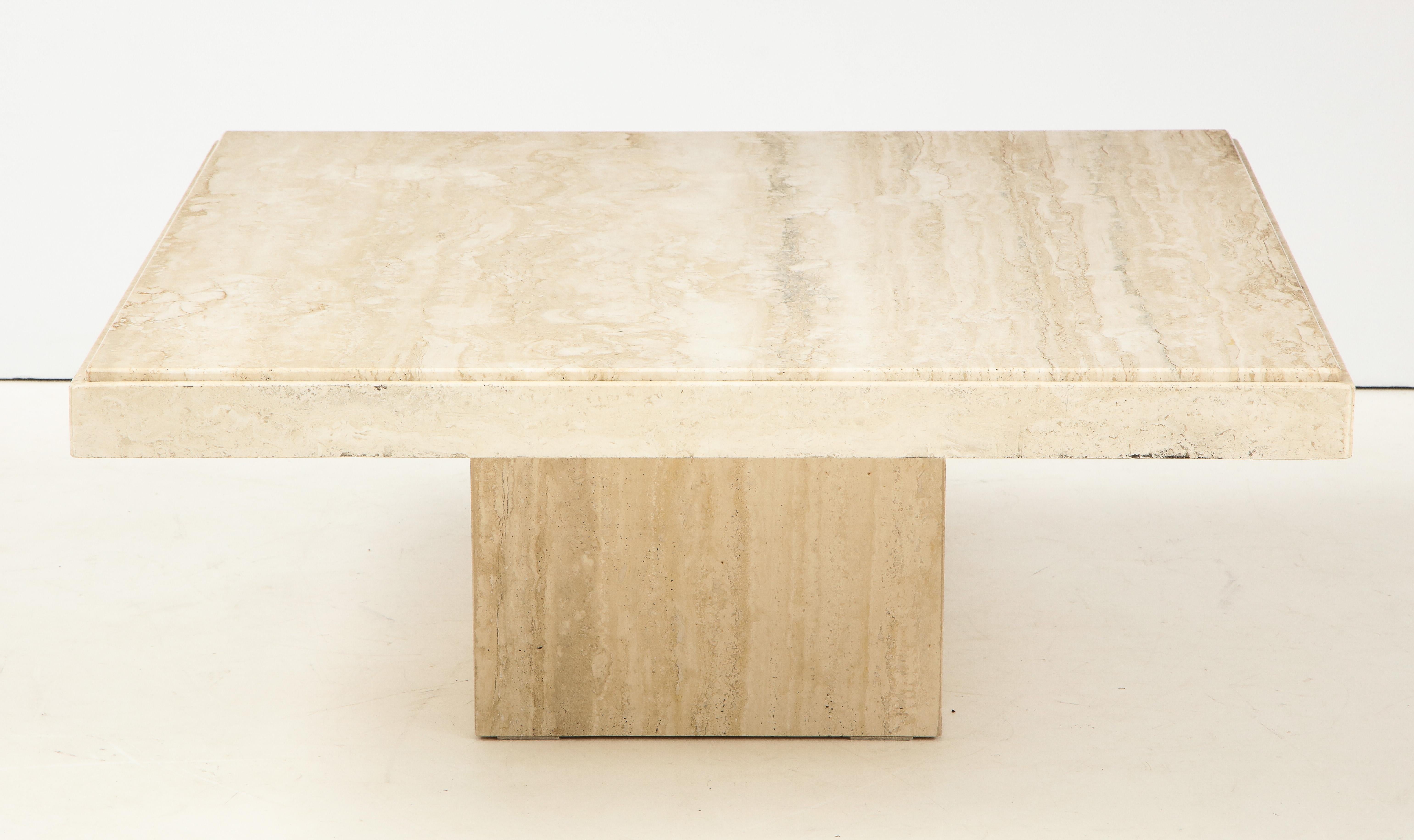 Italian travertine coffee table with beveled edge supported on a center square base. 
Italian, circa 1970
Size: 16