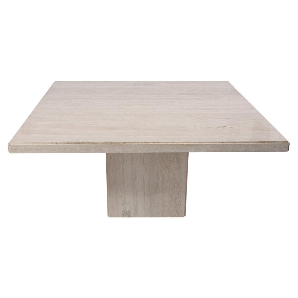Extraordinary 1970s dining table hand-crafted out of travertine marble. This table has an eye-catching has a large square top with rounded edges and seats on a floating base, This Minimalist dining marble table would make a great addition to any