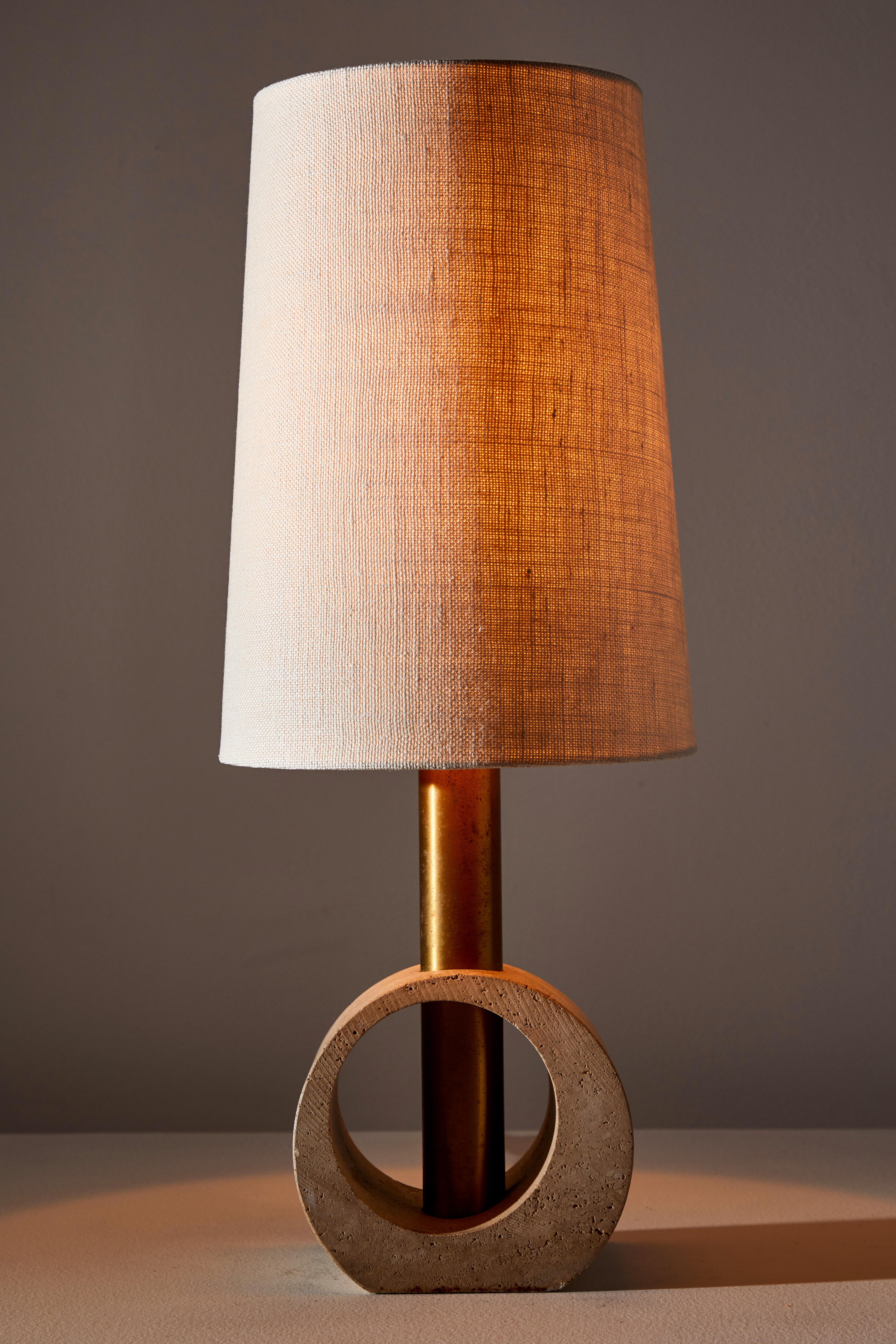 Table lamp. Designed and manufactured in Italy, circa 1970s. Travertine with custom linen shade and brass stem. Original cord. Takes one E27 60w maximum bulb. Bulbs provided as a one time courtesy.