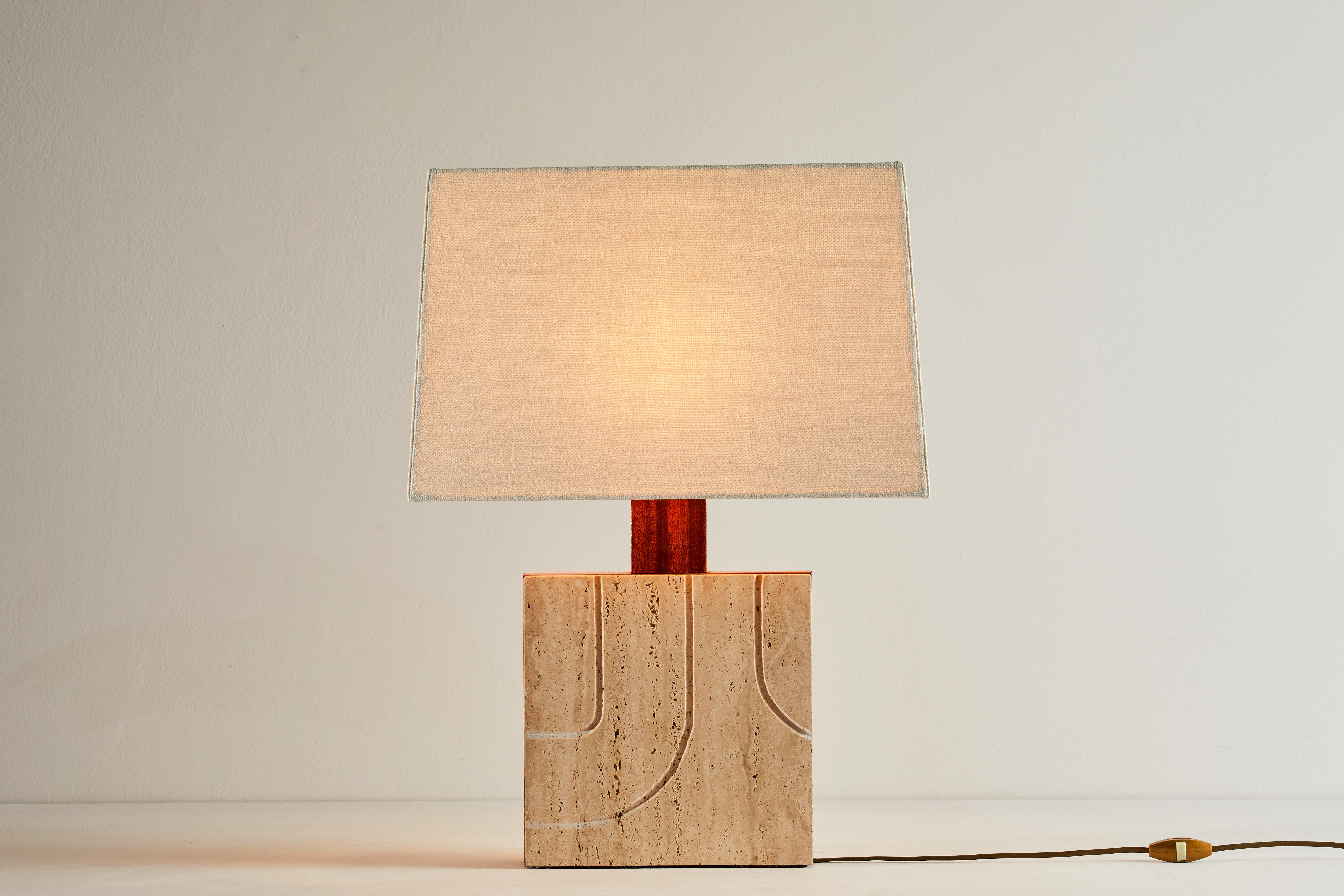 Travertine table lamp. Manufactured in Italy, circa 1970s. Travertine base with teak inlay. Custom linen shade. Original cord. Takes one E27 40w maximum bulb. Bulbs provided as a one time courtesy.