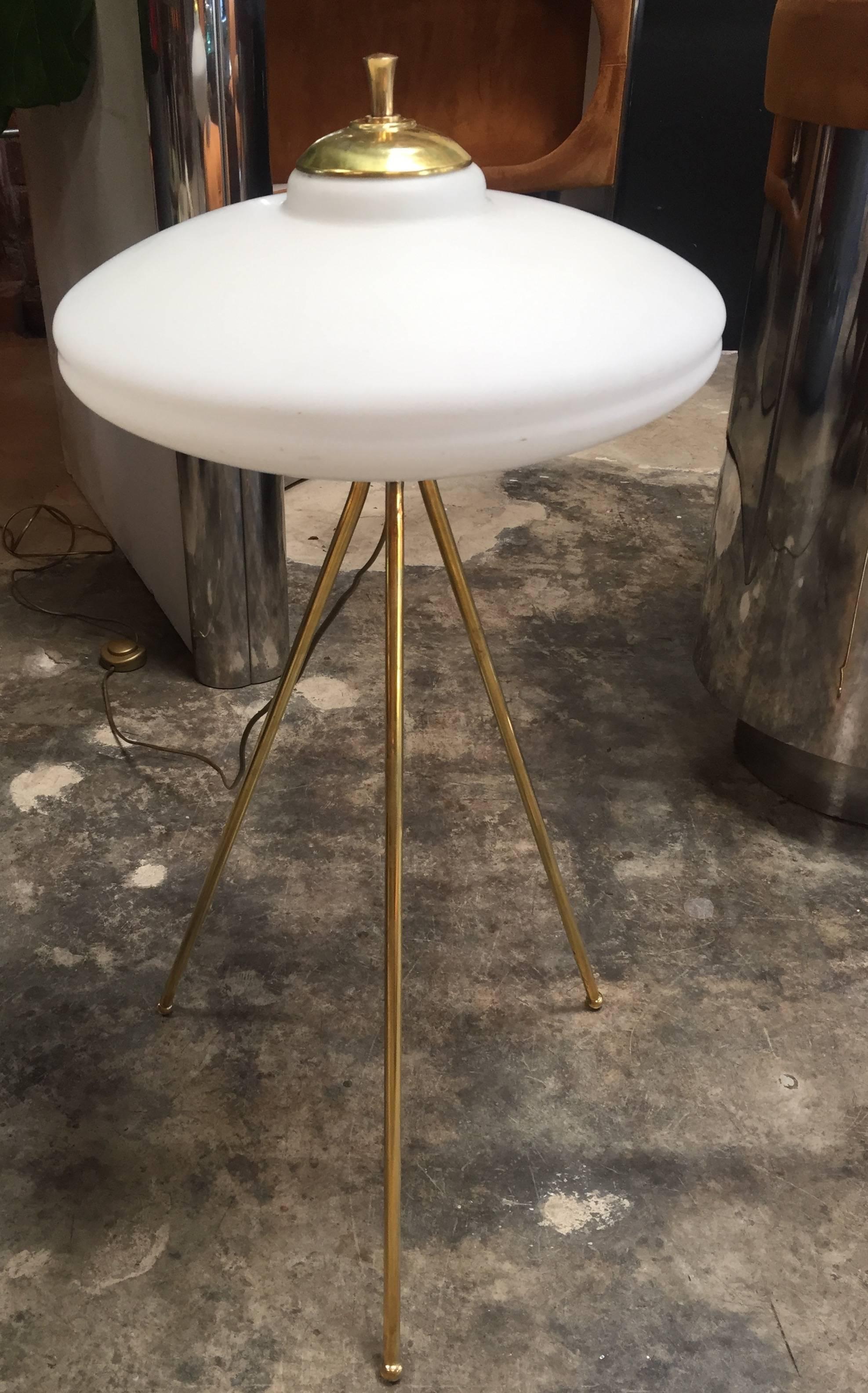 Italian tripod floor lamp is light and airy, but with a strong presence.
Each of the three stems in antique brass supports a softly glowing milk glass shade, 1960s.