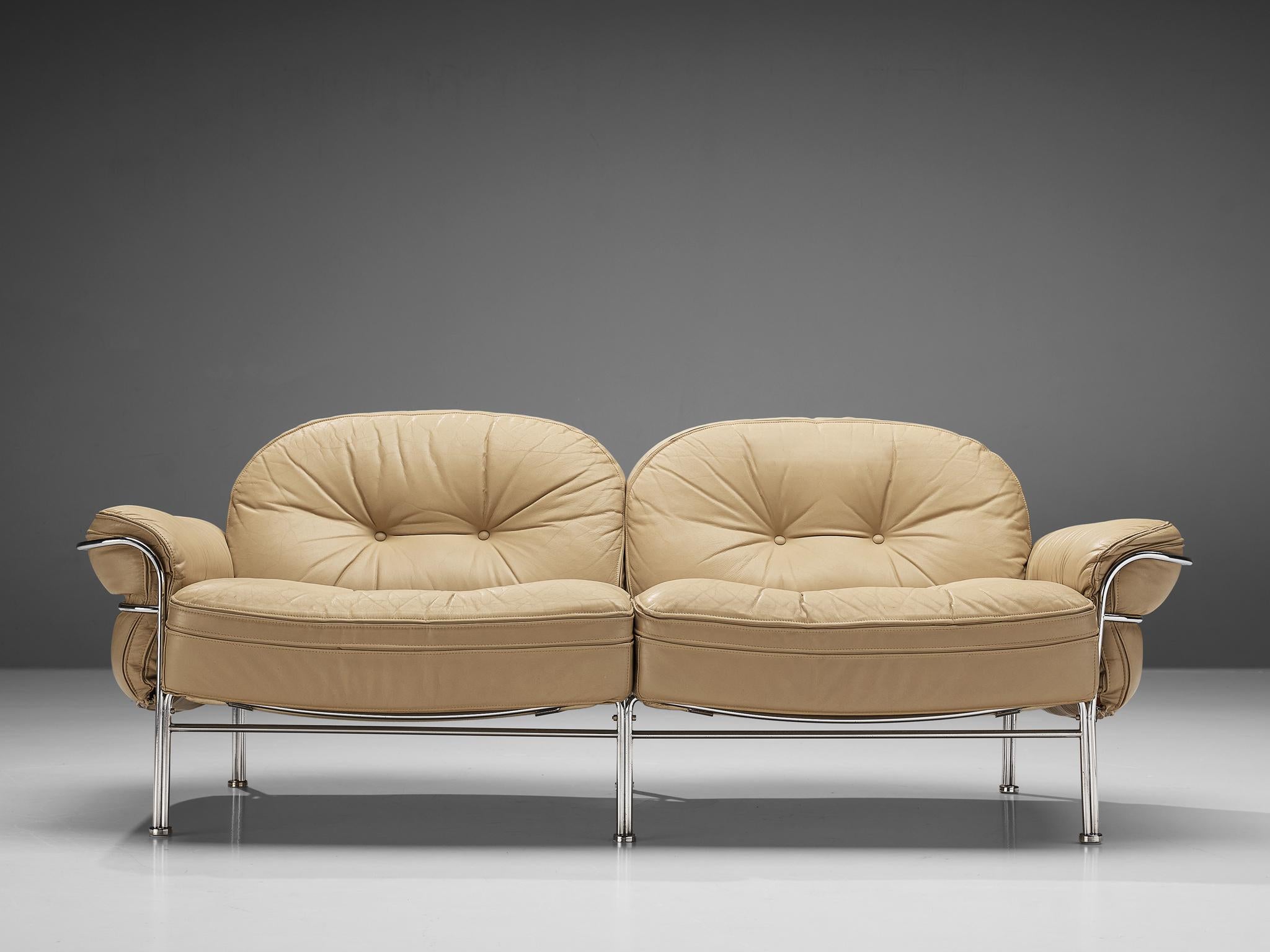 Sofa, metal, leather, Italy, 1960s.

Elegant, tubular two seat sofa. The sofa features a curved, chromed frame that holds the tufted, leather cushions. The piece has beautiful soft lines, such as rounded legs and the curved armrests. This softness