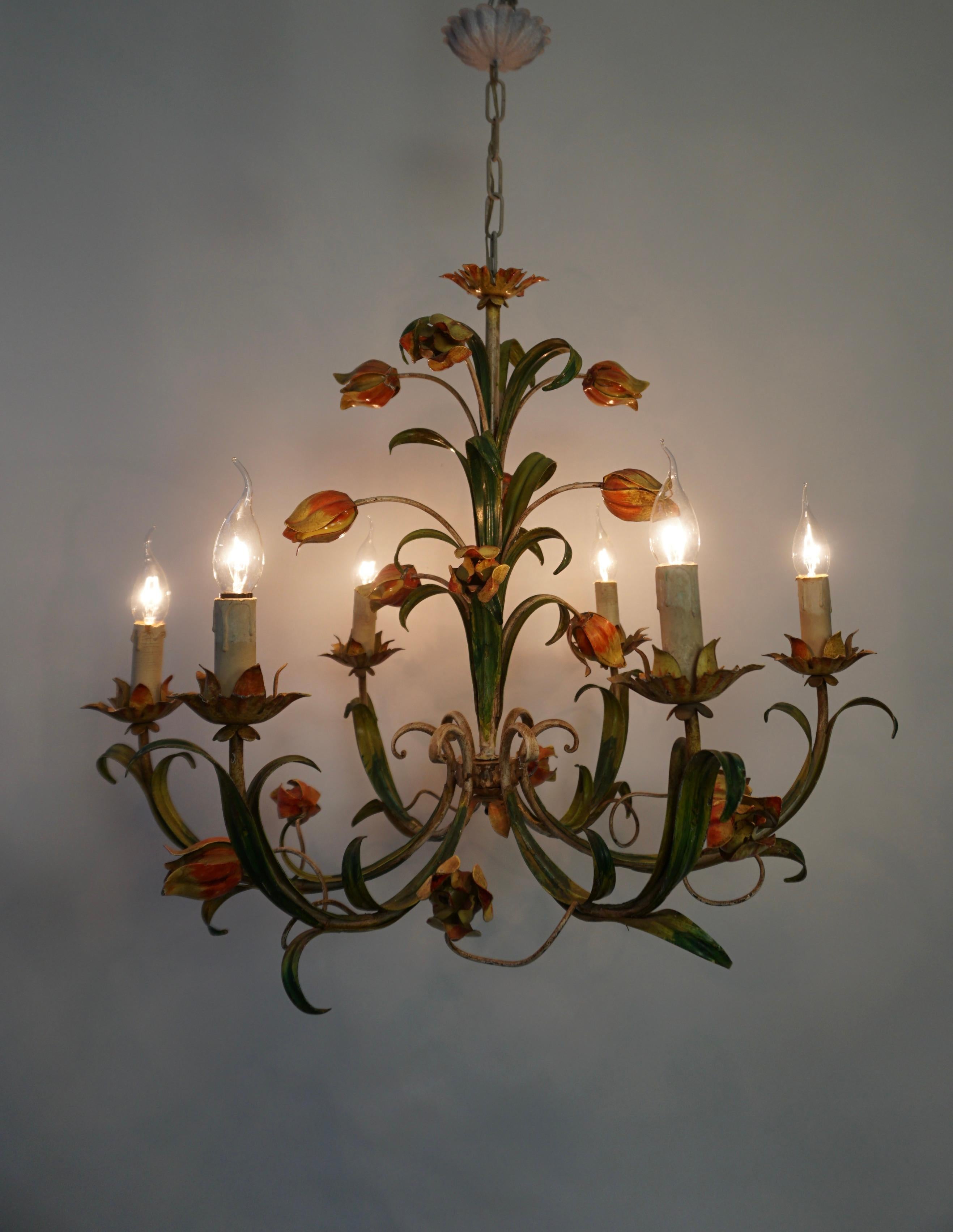 Large Italian Tole chandelier with beautiful tulip flowers.

A large Hollywood Regency six-armed tole flower chandelier from Italy manufactured in the mid-century (1960s and 1970s). The lamp has six sockets for small incandescent lamps with screw