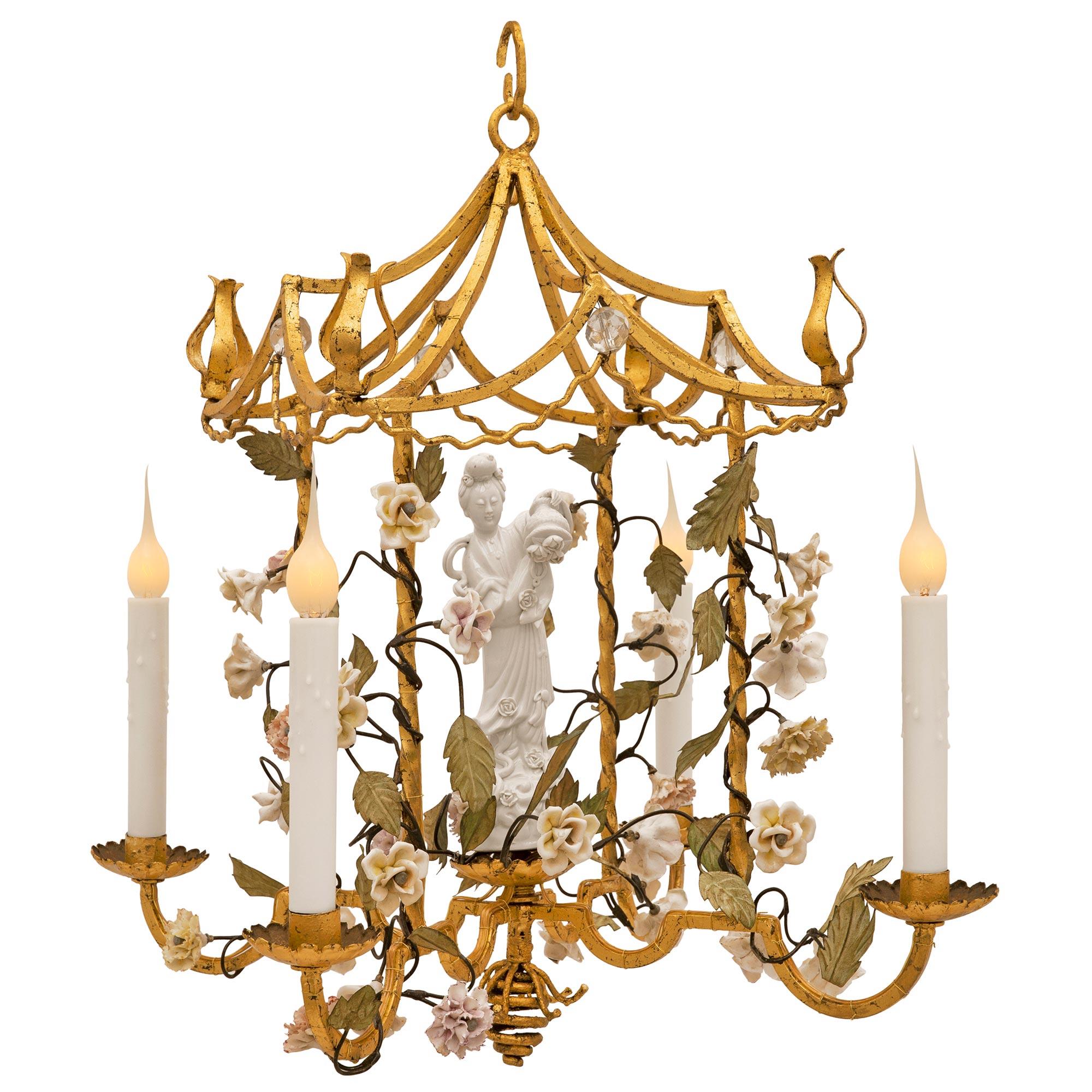 A unique and extremely decorative Italian turn of the century gilt metal, Blanc de Chine porcelain and tole chandelier. The four arm chandelier with Asian influence is centered by a beautiful spiraled bottom finial below the elegantly curved gilt