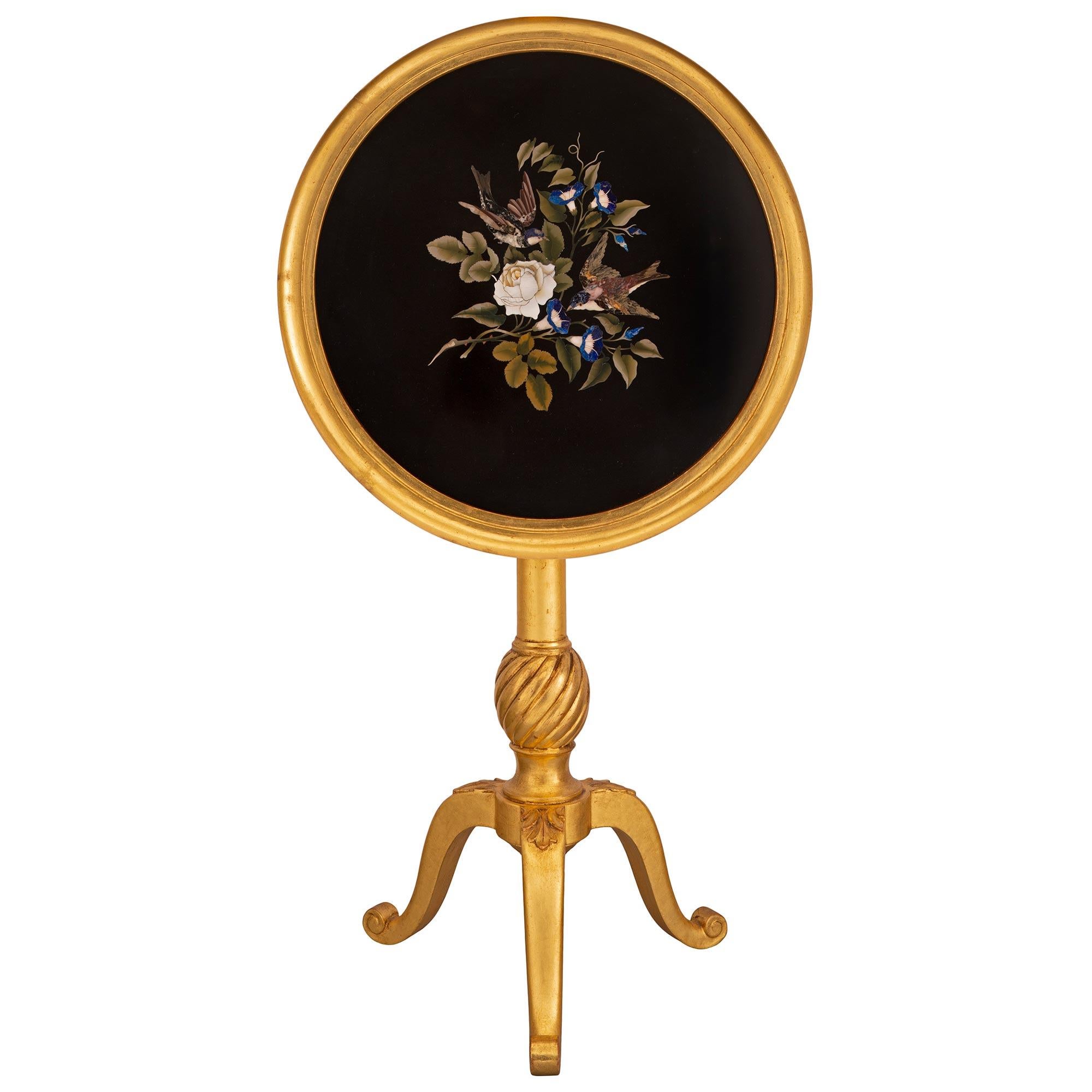 A striking and most elegant Italian turn of the century Florentine st. giltwood and pietra dura marble side table. The circular inlaid tilt top side table is raised by three elegantly curved legs with fine scrolled feet and charming palmette