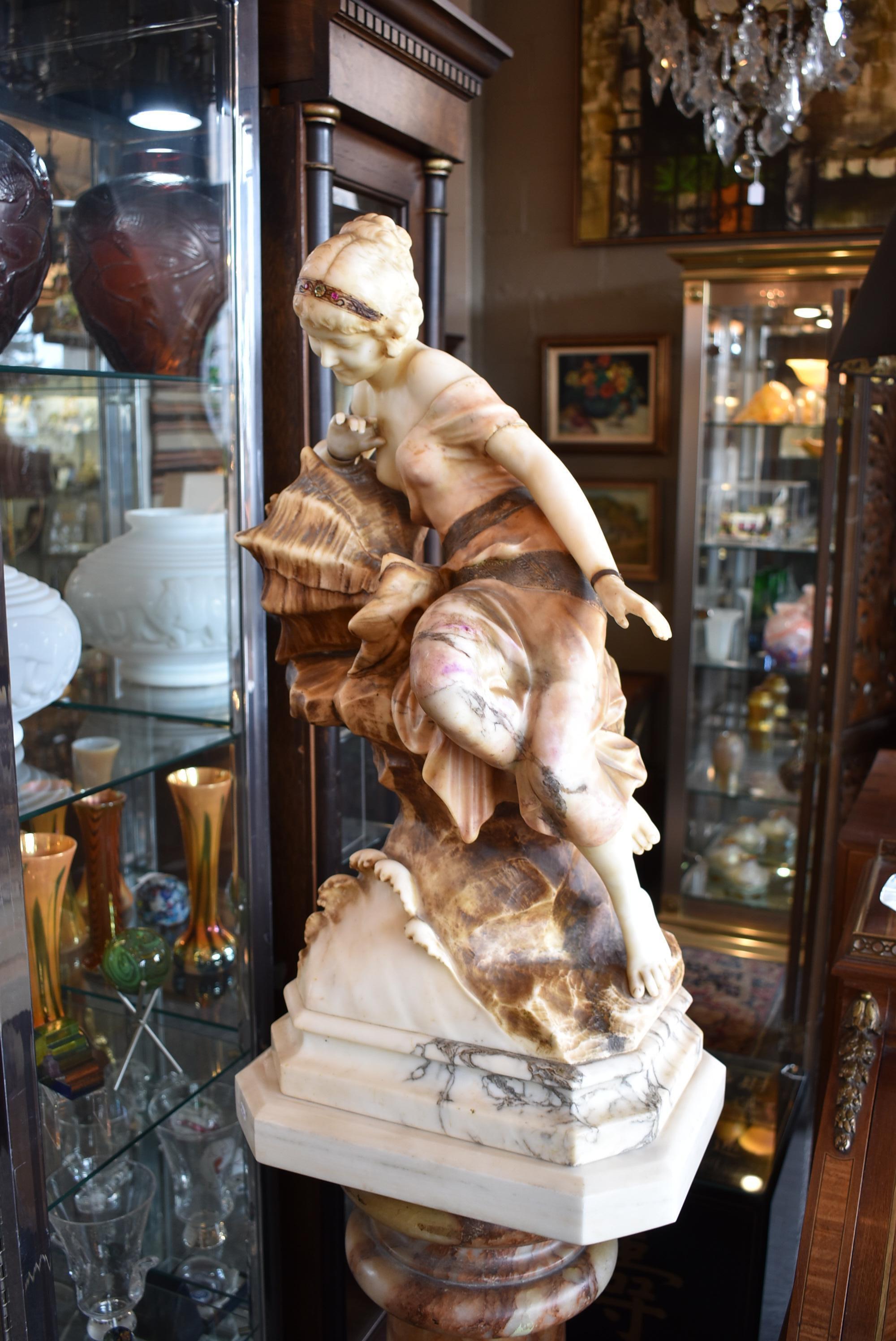 Italian marble turn of the century carved sea maiden sculpture. Young lady perched on a rock. Conch shell lights up from the back side. Very nice condition. Dimensions: 13