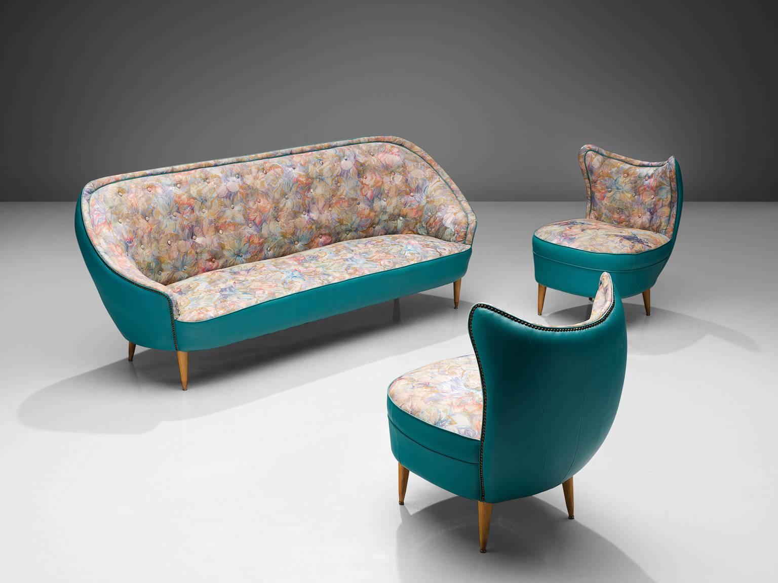 Living room set, sofa, lounge chairs, turquoise leatherette, fabric, wood, Italy, 1950s.

These easy chairs and sofa show traits of the design by the Italian designer Veronesi. They are elegant yet bulky and are completely rounded when seen from