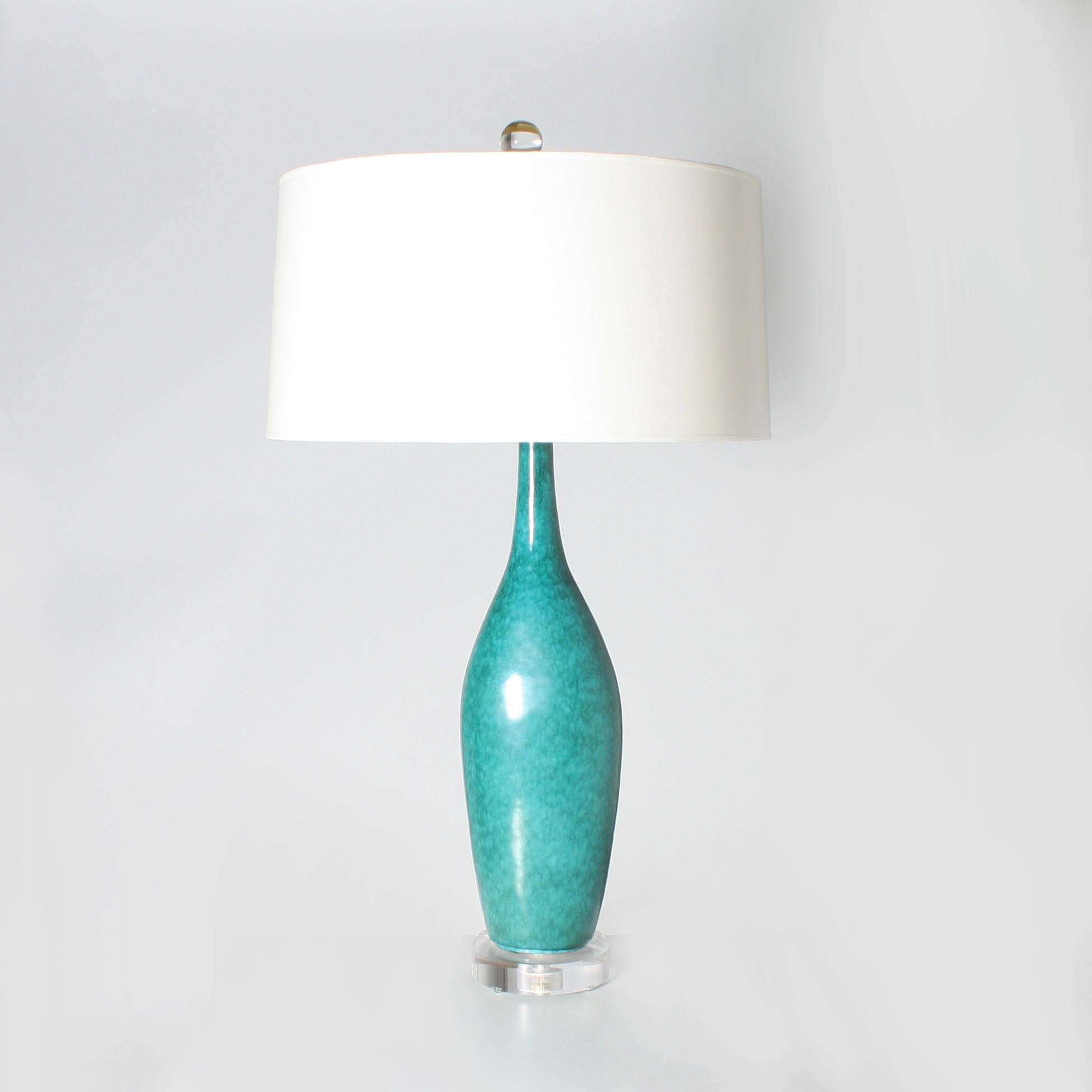 Italian turquoise Marcello Fantoni ceramic lamp. Ivory lacquer shade with gold foil interior. Three way socket, 50/100/150 watt. Brass hardware. Lucite base. Crystal ball finial. Gold twisted cording.