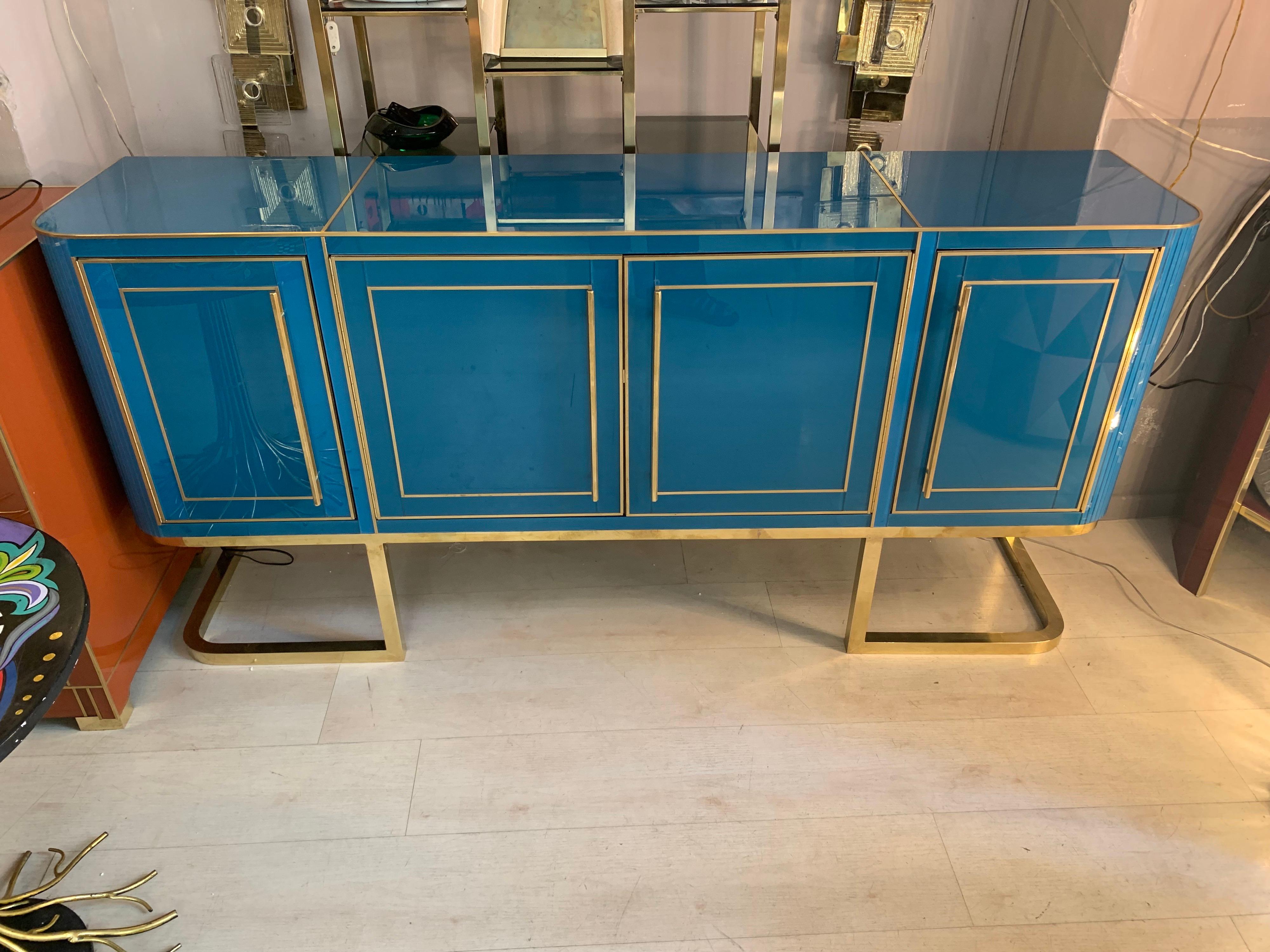 Italian turquoise opaline glass credenza with inlays, brass handles and legs.
The chest has four doors with shelves inside.