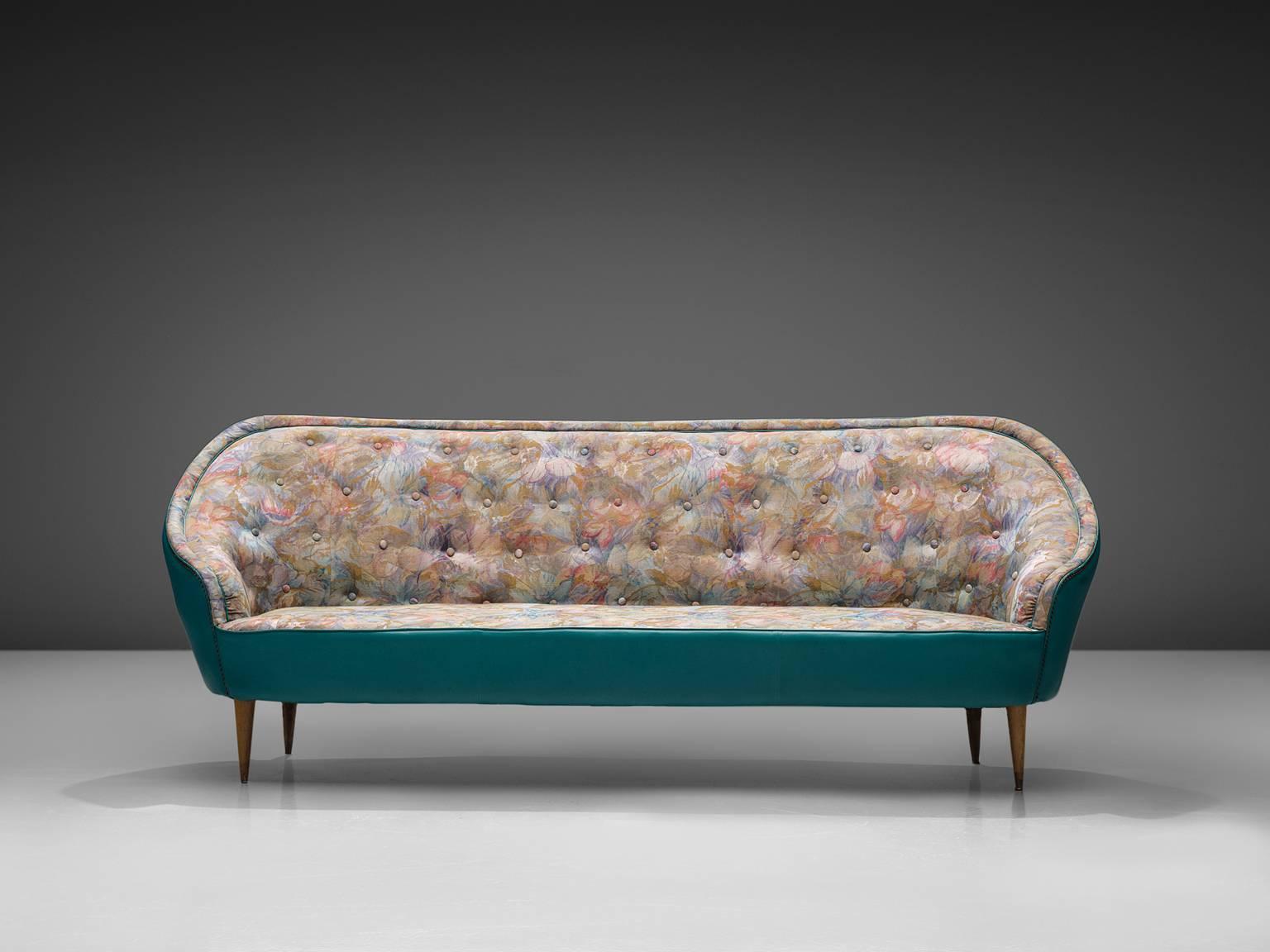 Sofa, turquoise leatherette, fabric, wood, Italy, 1950s.

This sofa show traits of the design by the Italian designer Veronesi. The sofa is elegant and bulky and is completely rounded when seen from behind. The piece features a rounded, buttoned