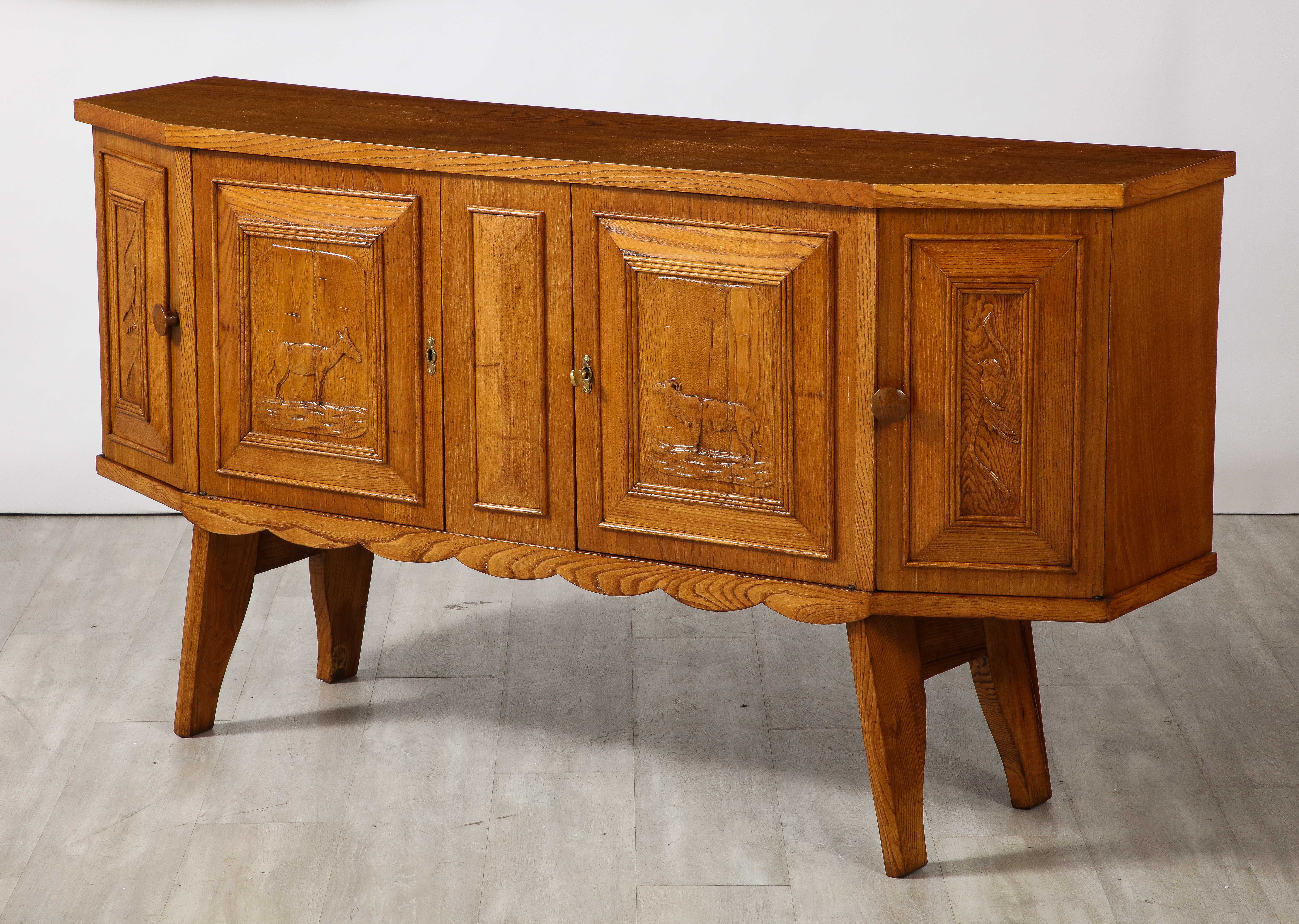 A charming and beautiful Tuscan hand-carved oak credenza or side board, circa 1940. 

The piece displays excellent craftsmanship combined with an eye for composition and functionality. The whole case with four doors, each with raised panels; the