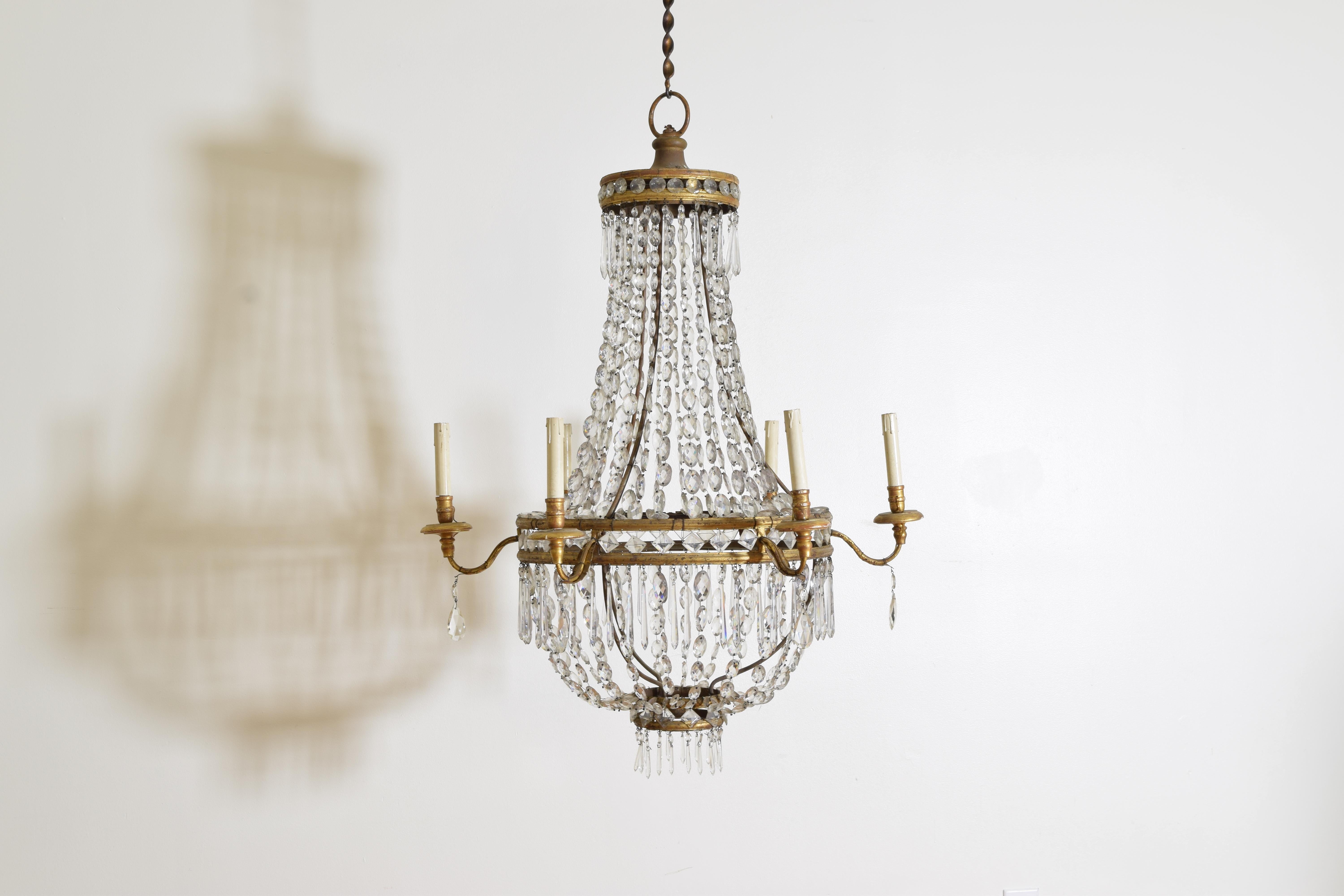 Elegantly formed in a larger-scale basket shape with gilded bandings connecting the cut crystals.