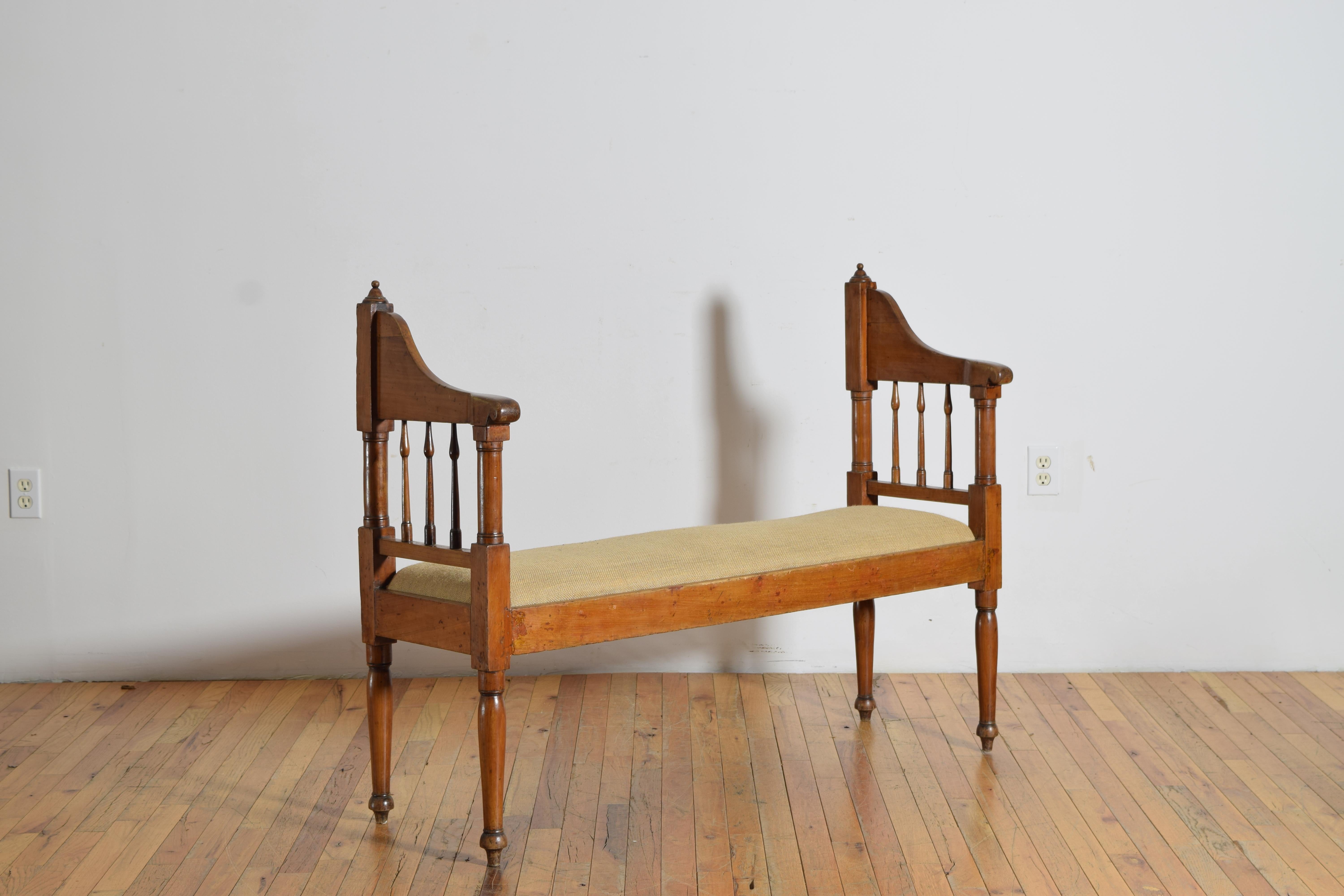 the rectangular frame with an upholstered drop-in seat raised on turned legs, the frame with shaped and turned 