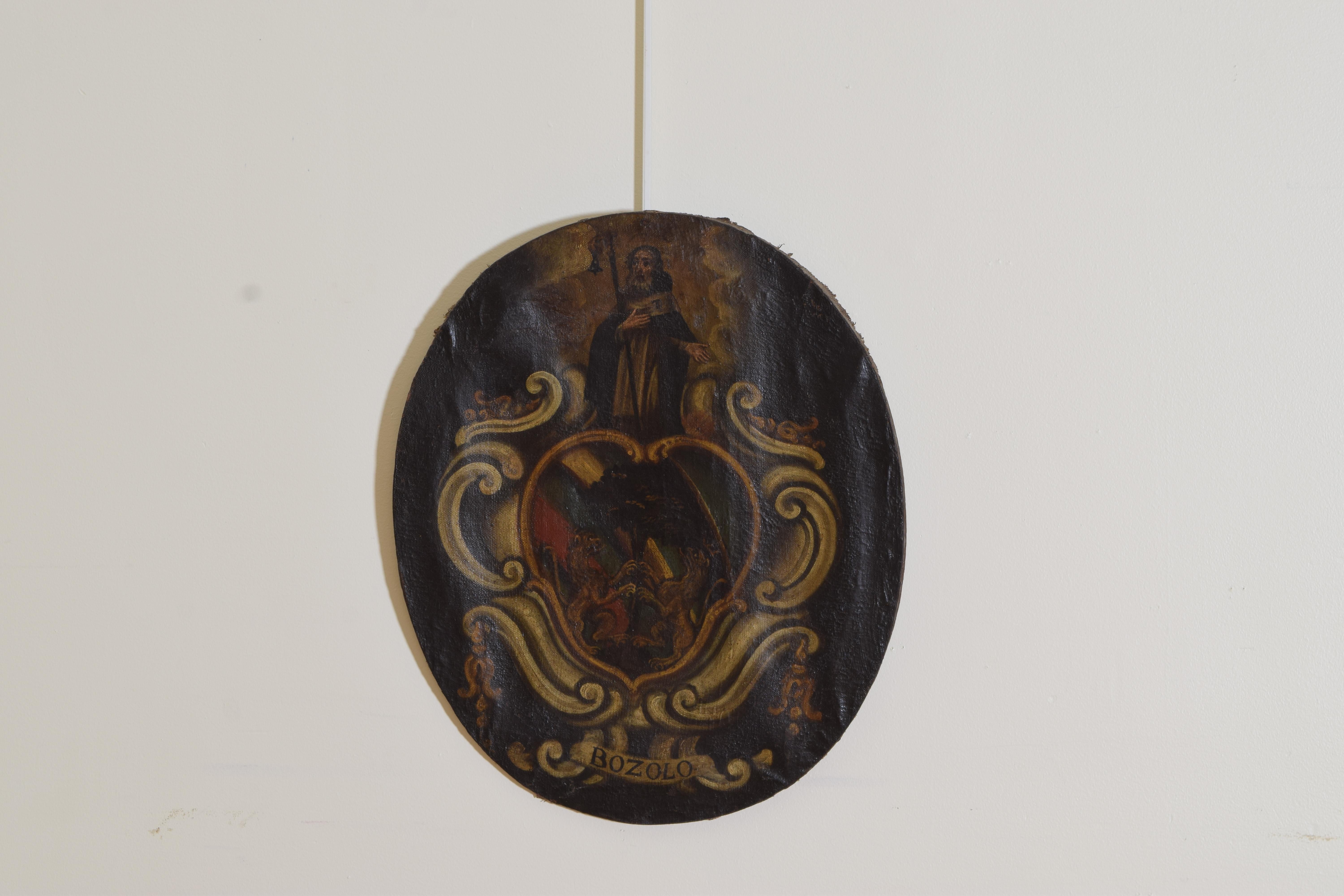 The oval painting featuring Saint Christopher emerging from parting clouds standing atop a ground of intertwined c-scrolls, at the center is a tree with two lions ascending, the family name Bozolo centered at the bottom.