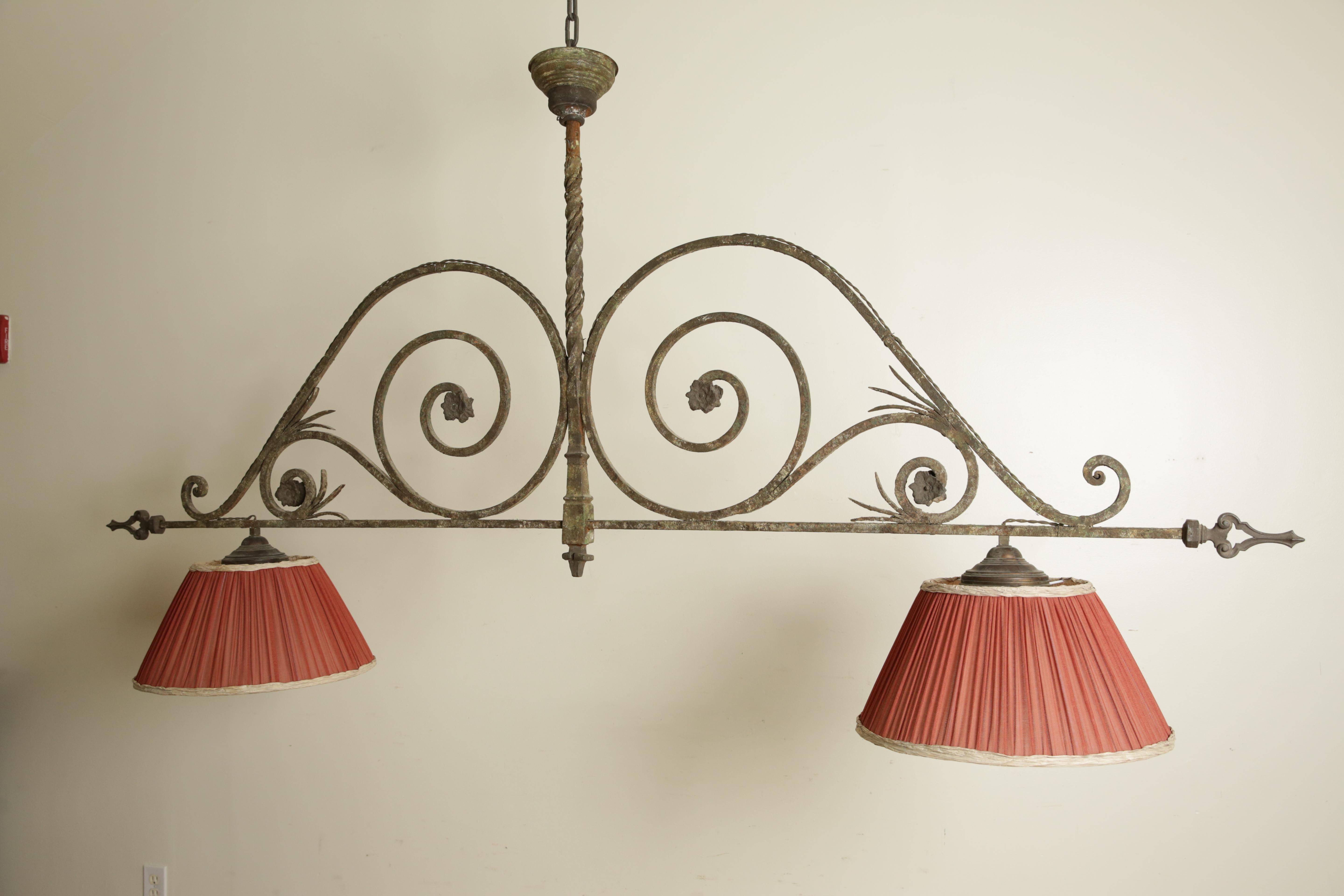centered around a standard issuing horizontal arms with large srolls joining both elements, outwired for electricity and including custom lampshades, dimensions are inclusive of shades, depth of central standard 2